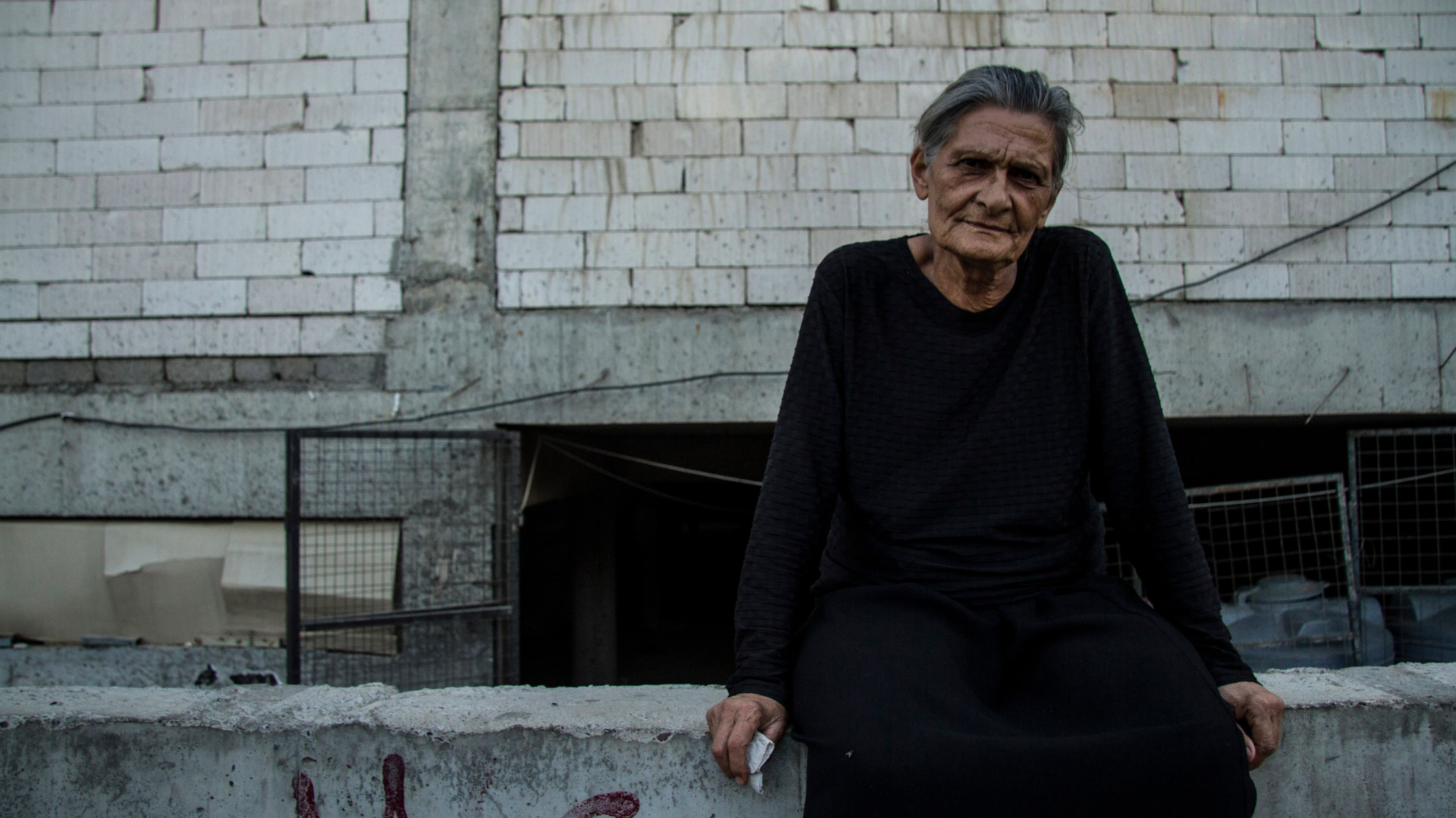 Leila Mansour, from a village outside Mosul, is in her 70s and now lives in the half-finished mall behind her. She says she knows she’ll probably never go home.