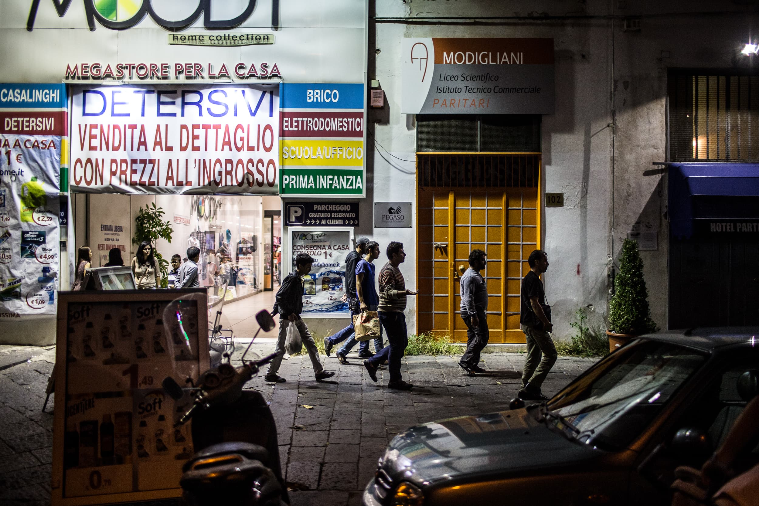 Syrian Asylum seeker Nawras Soukhta walks through the streets at night in Naples, Italy.