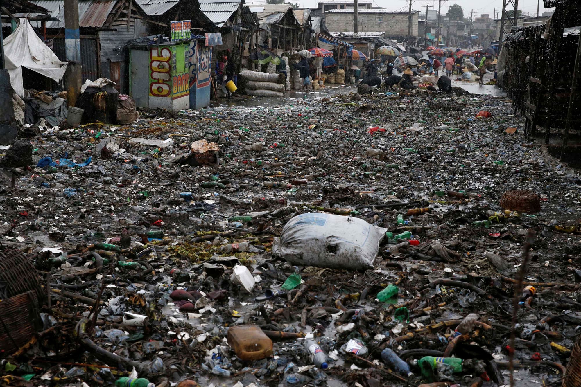 People wade across a flooded street while Hurricane Matthew passes through Port-au-Prince, Haiti.