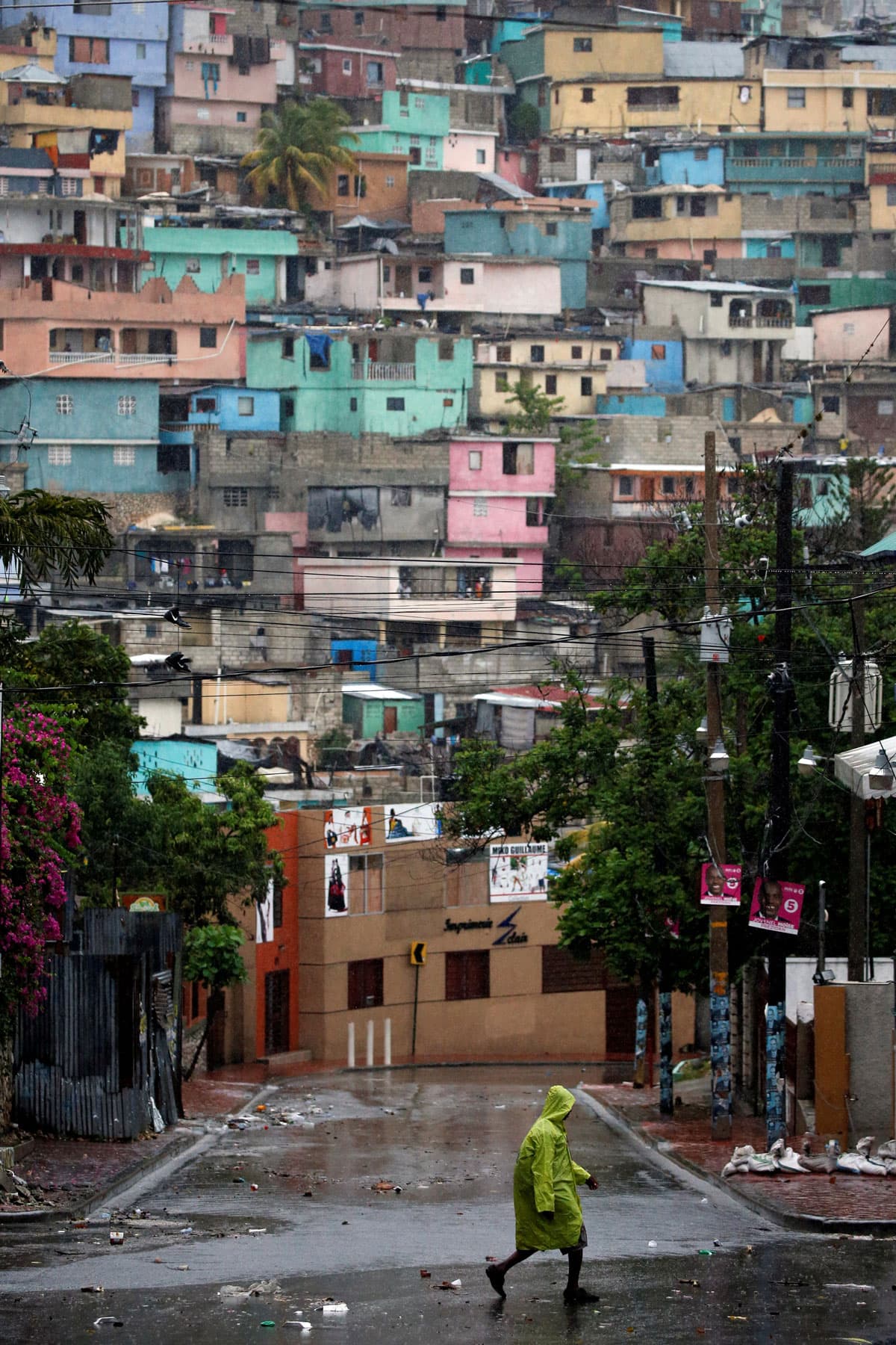A man walks down the street while Hurricane Matthew passes through Port-au-Prince, Haiti.
