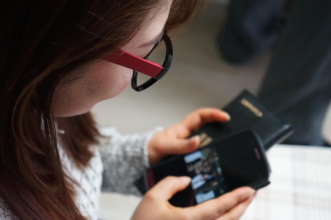 24-year old North Korean refugee Danbi swipes through photos on her mobile phone.  She has no contact with family back home, she says.  But some North Korean refugees continue to communicate with their families in the North, via care packages and smuggled