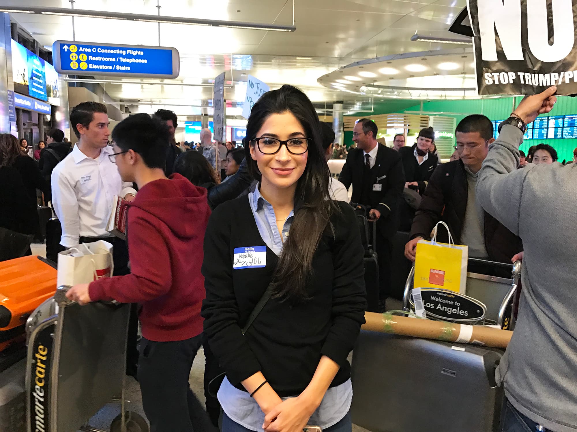 Woman with name tag standing in crowd