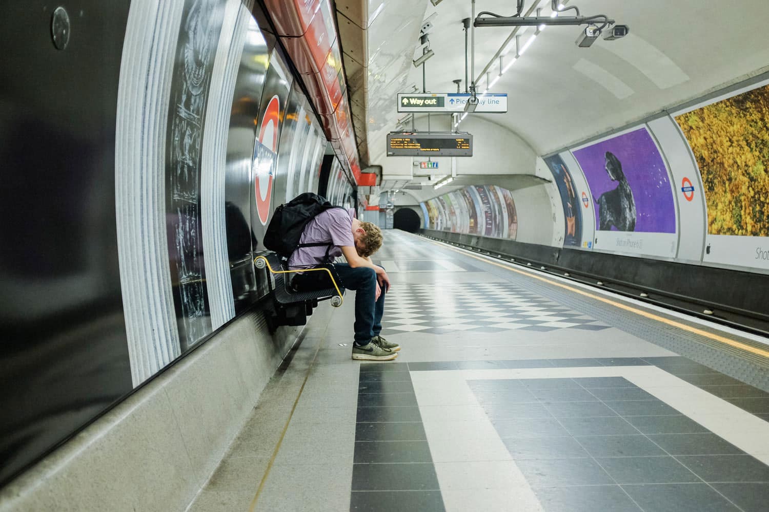A passenger headed east takes a few moments to gather his thoughts while waiting for the next train to Hainault. During the night service trains ran at an average of 14 minute intervals, not the usual 3-4 minutes.