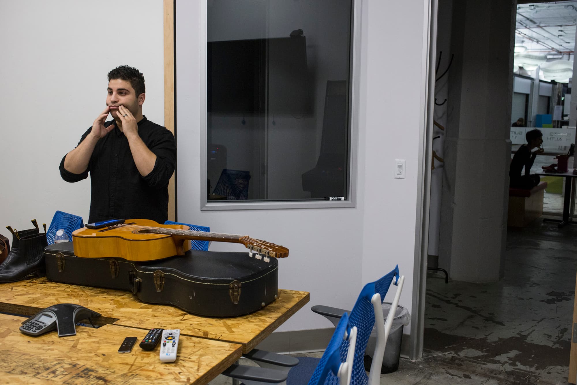 Omar performs music he calls nuevo mariachi. Here he his warming up for a performance.