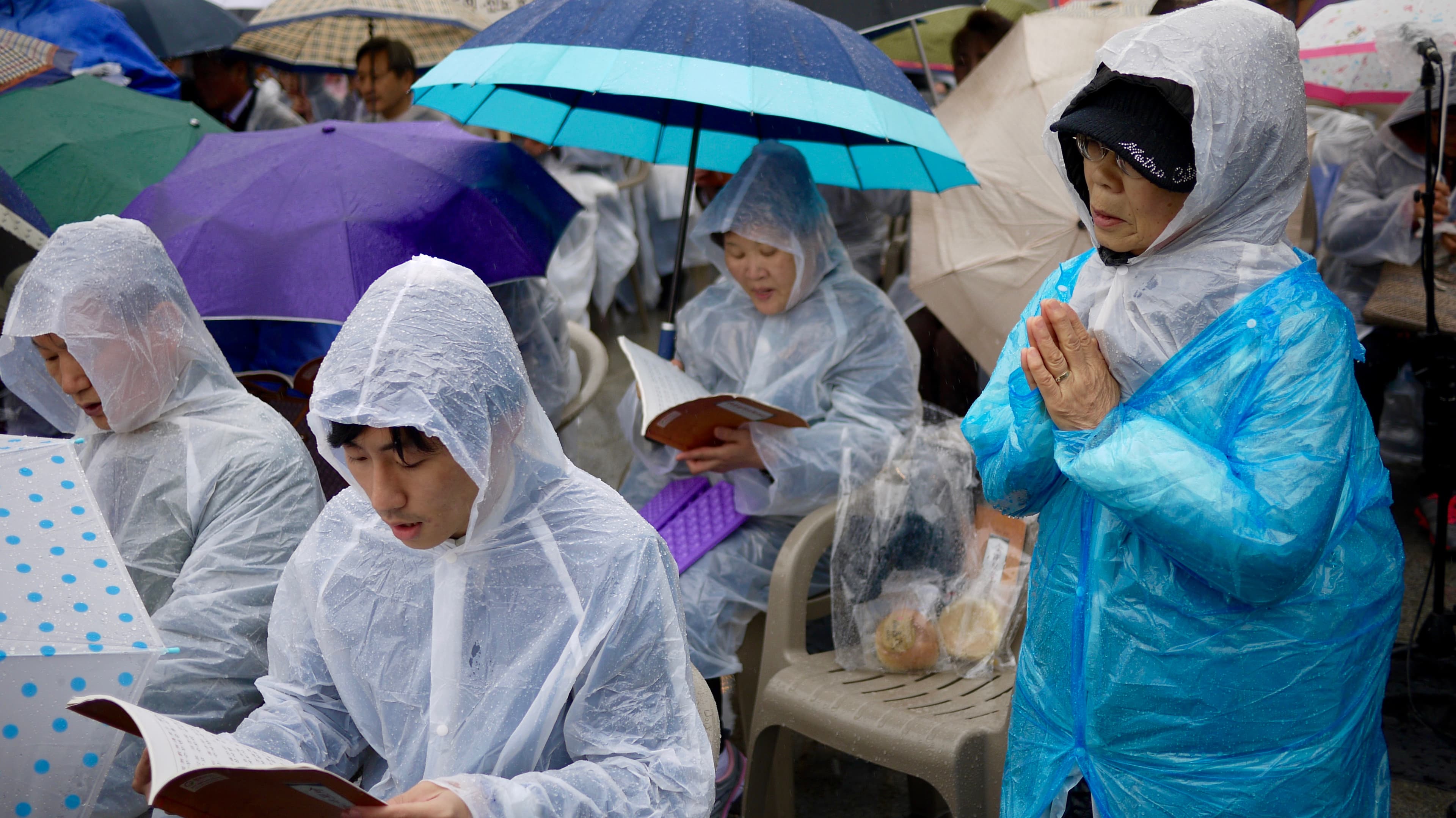 South Korean Buddhists tried to stay dry during this year's event.