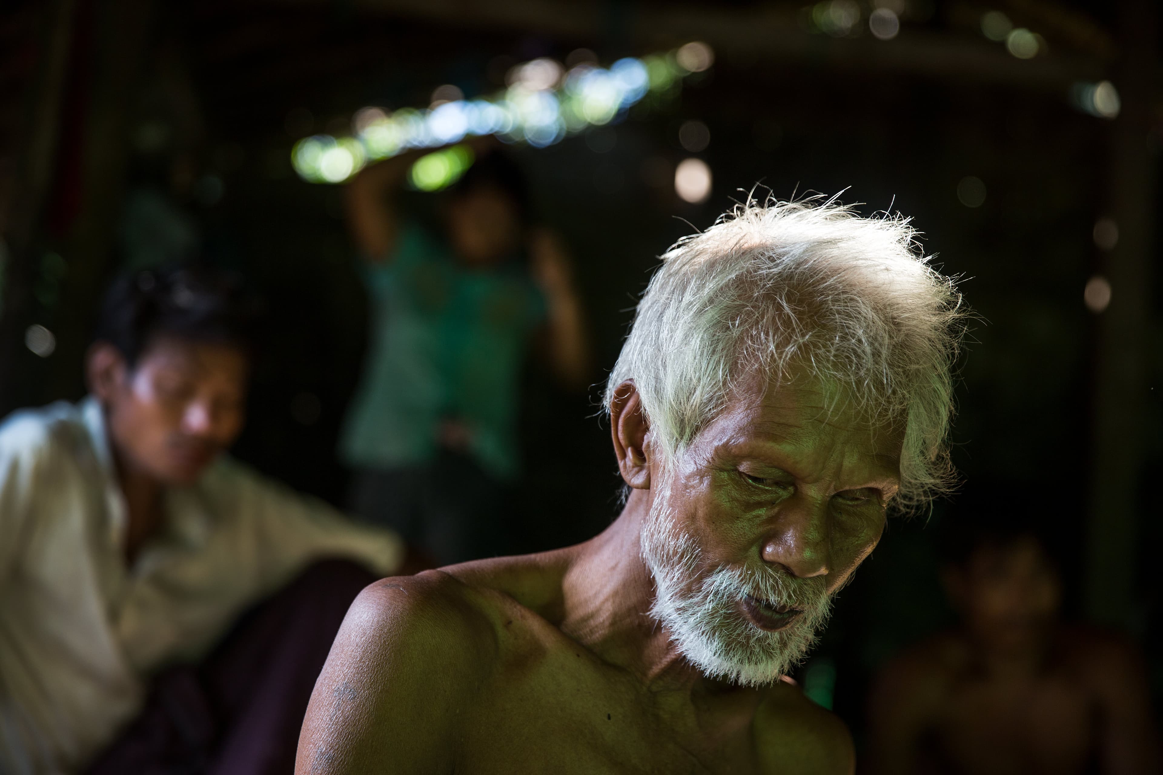 U Hla Myint, 65, sits in his home at a small village where migrant workers for Supowin Palm Oil live outside Kawthaung, Myanmar, Nov.14, 2016. Myint and his wife retired five years ago. They're now supported by two sons.