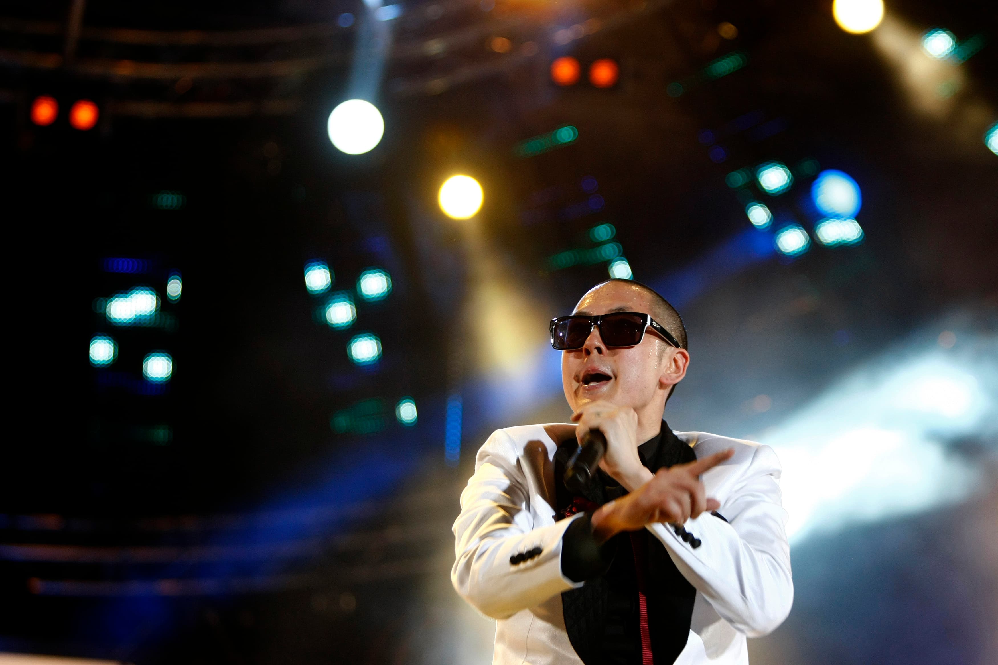 Man on stage singing into microphone