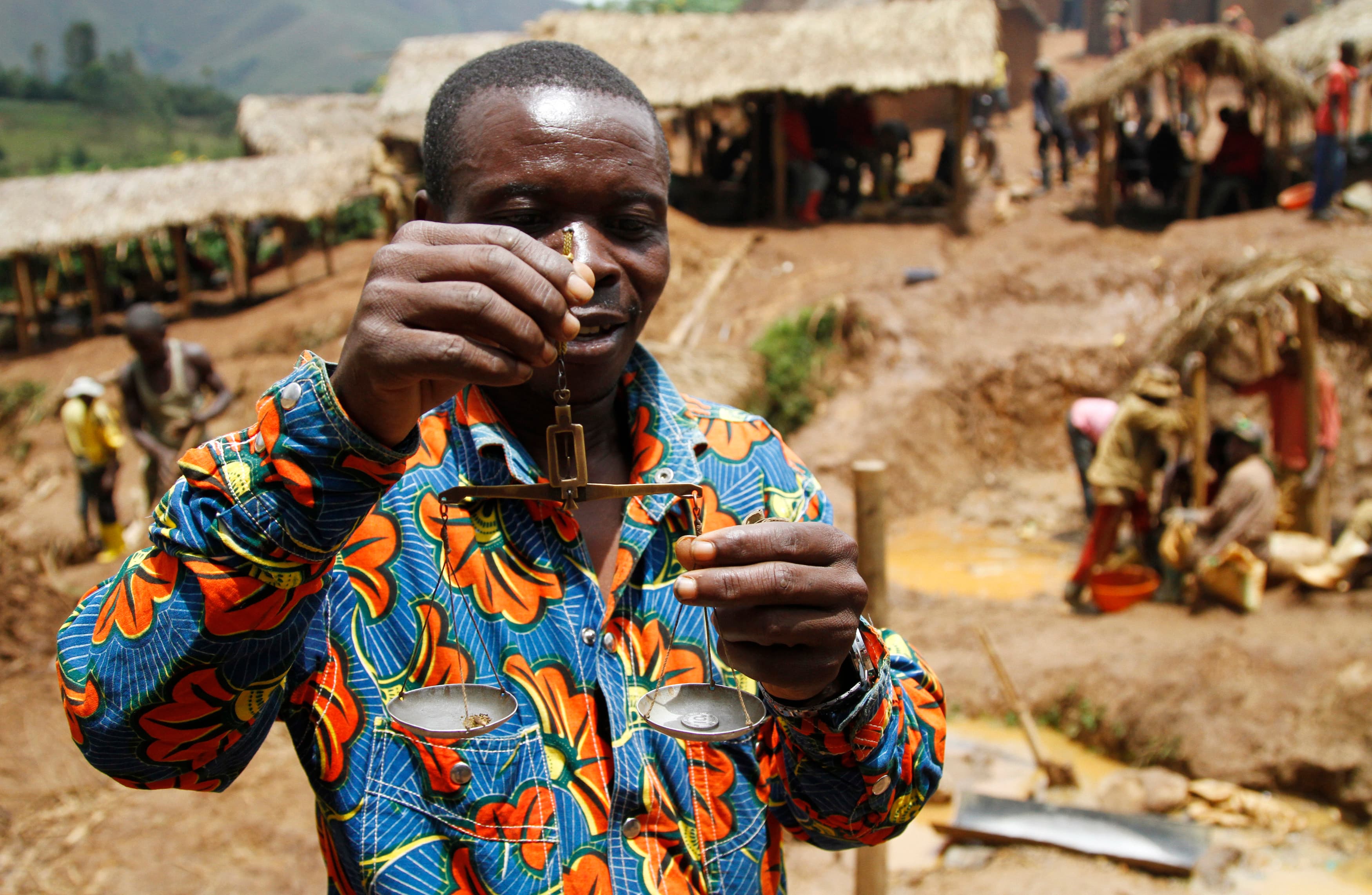 A trader weighs gold nuggets at an illegal mine-pit in Walungu territory of South Kivu province near Bukavu, DRC, April 5, 2014.