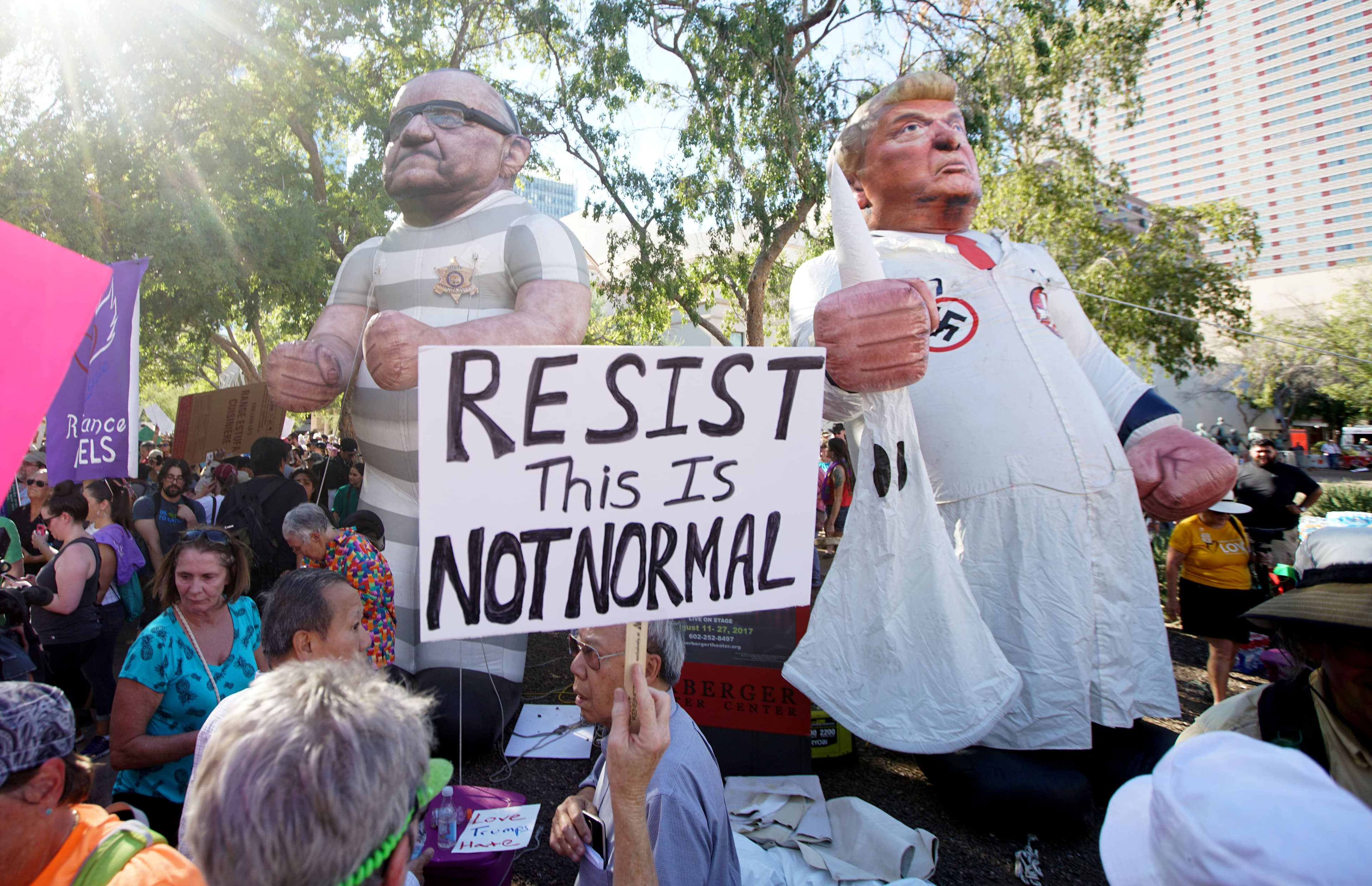Protesters demonstrate outside President Donald Trump's campaign rally in Phoenix, Arizona, Aug. 22, 2017.