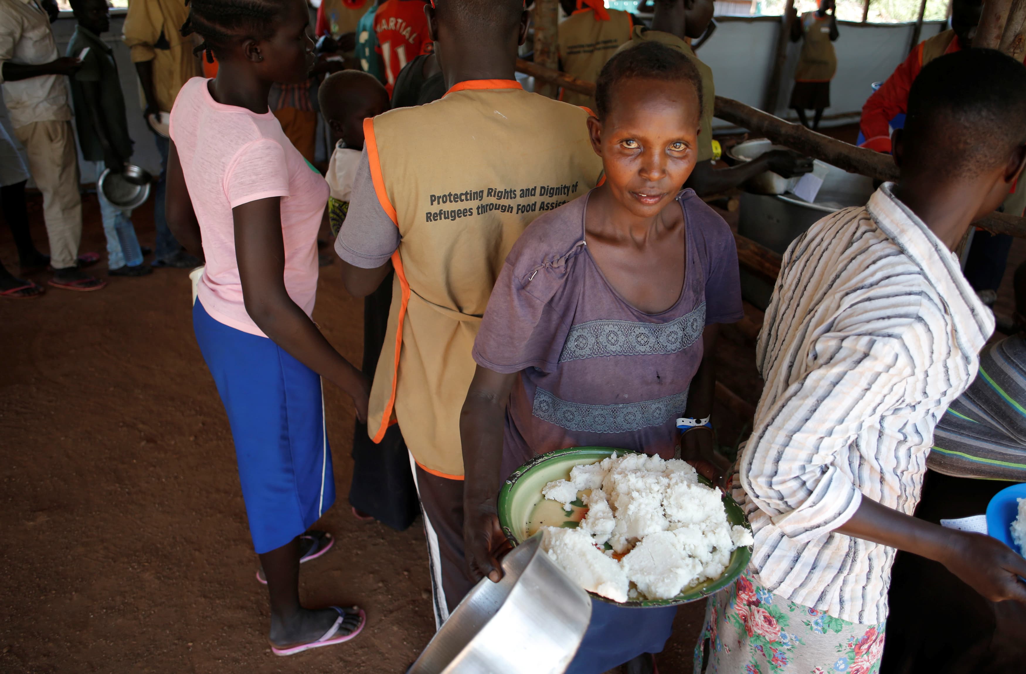 A South Sudanese woman collects a meal in Omugo refugee settlement camp in northern Uganda on Aug. 23, 2017.