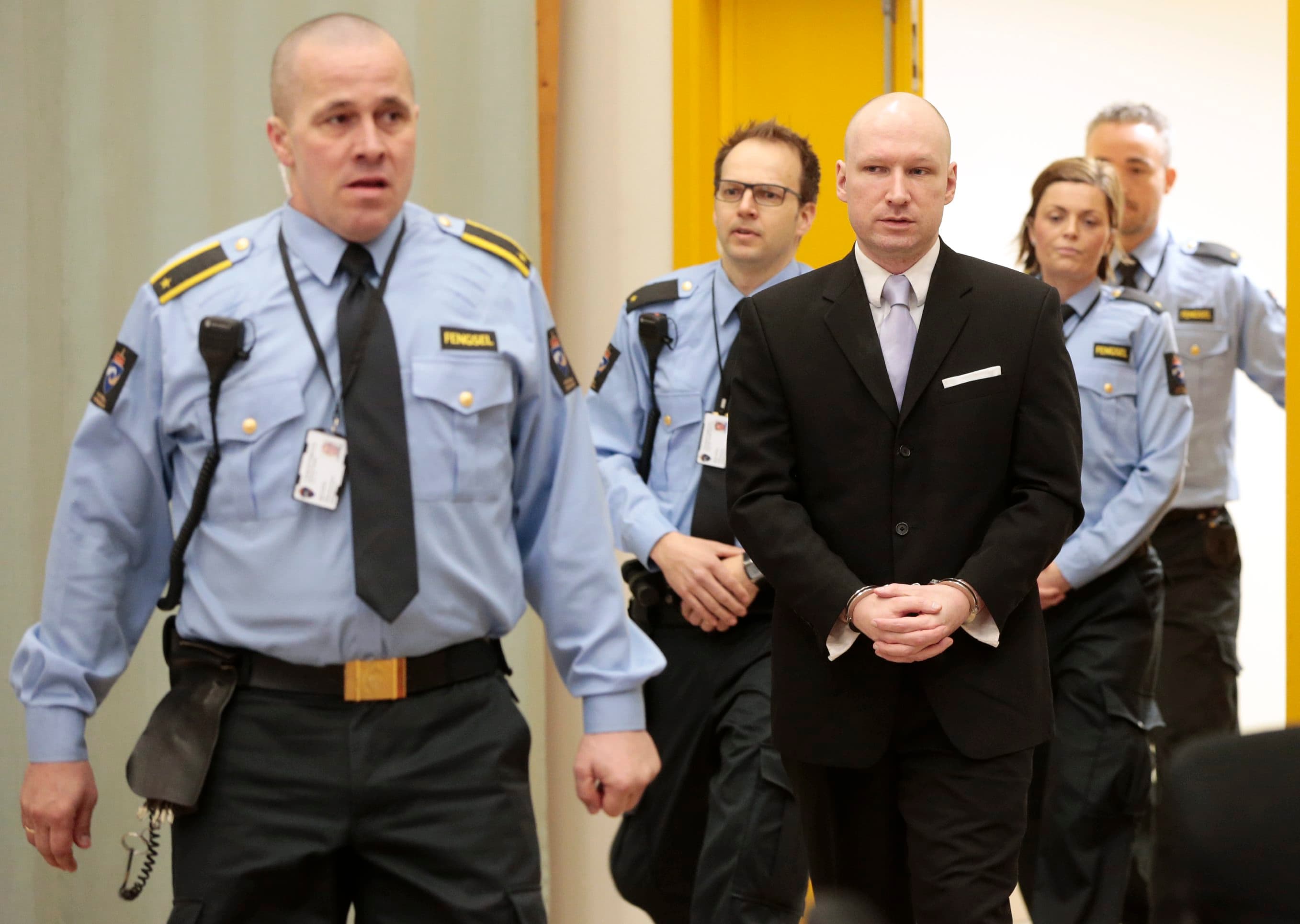 Mass killer Anders Behring Breivik is seen surrounded by prison guards on the fourth and last day in court in Skien prison, Norway March 18, 2016.