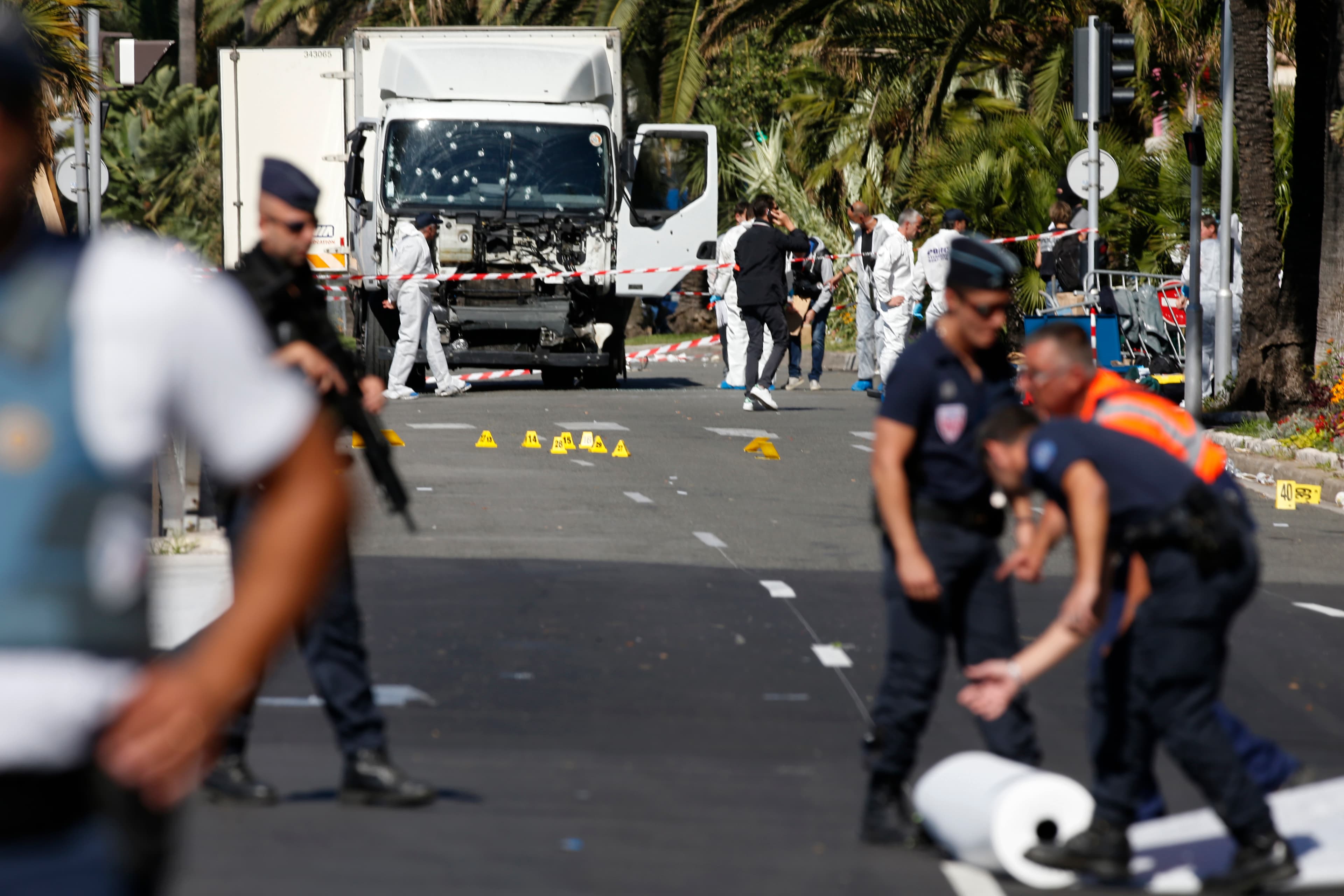 French police secure the area as the investigation continues at the scene near the heavy truck that ran into a crowd at high speed killing scores who were celebrating the Bastille Day July 14 national holiday on the Promenade des Anglais in Nice, France,