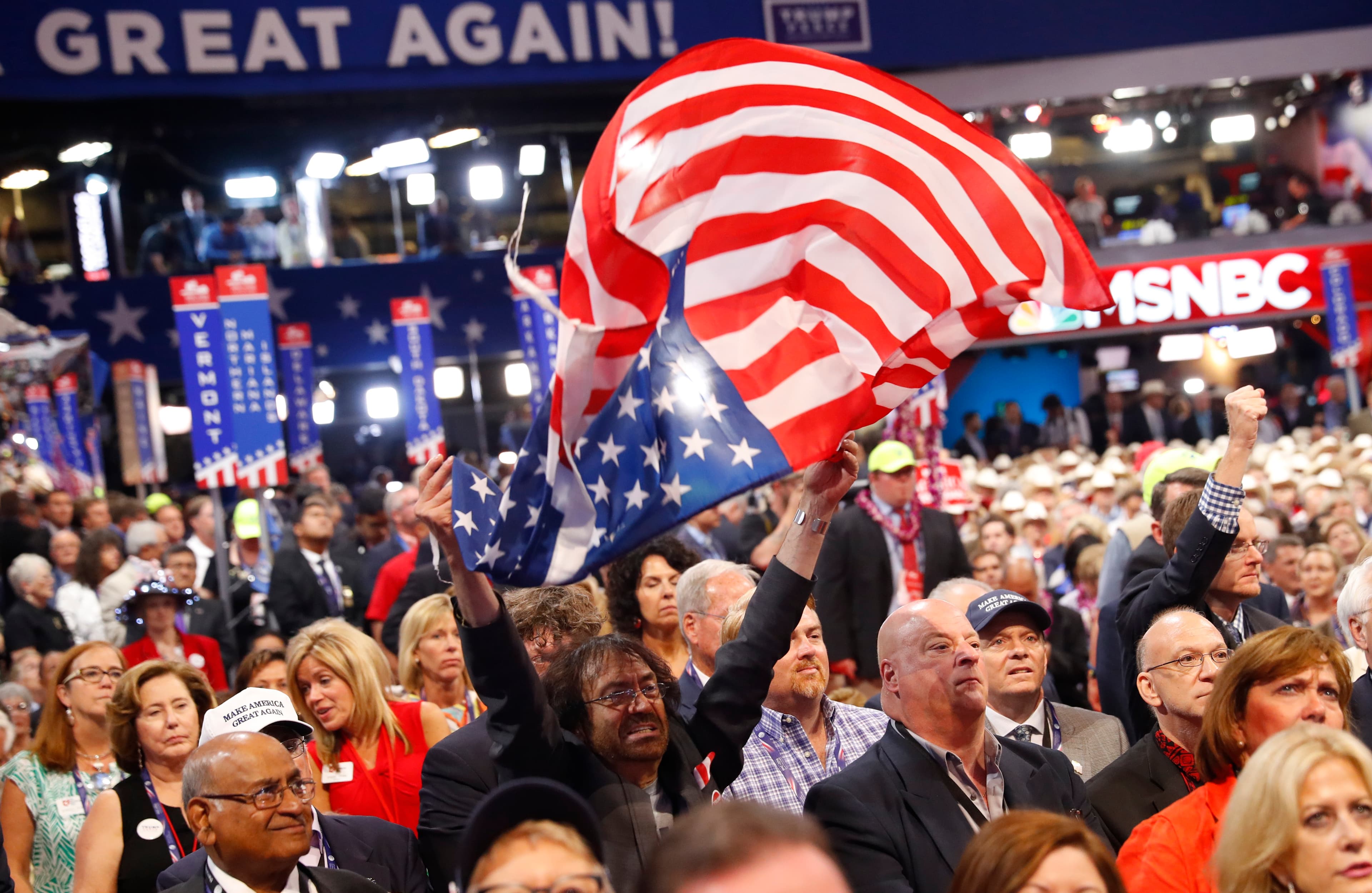 A delegate waves a United States flag during the third session at the Republican National Convention in Cleveland, Ohio, U.S. July 20, 2016.