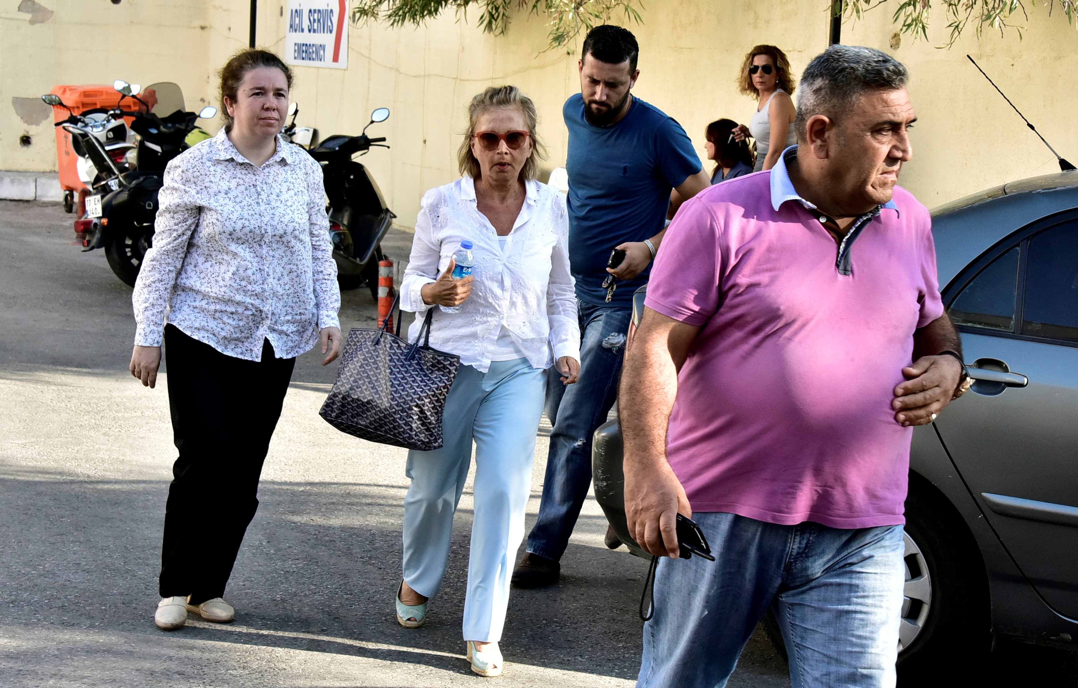 Turkish journalist Nazli Ilicak (C), also a well-known commentator and former parliamentarian, is escorted by a police officer (R) and her relatives (L and rear) after being detained and brought to a hospital for a medical check in Bodrum, Turkey, July 26