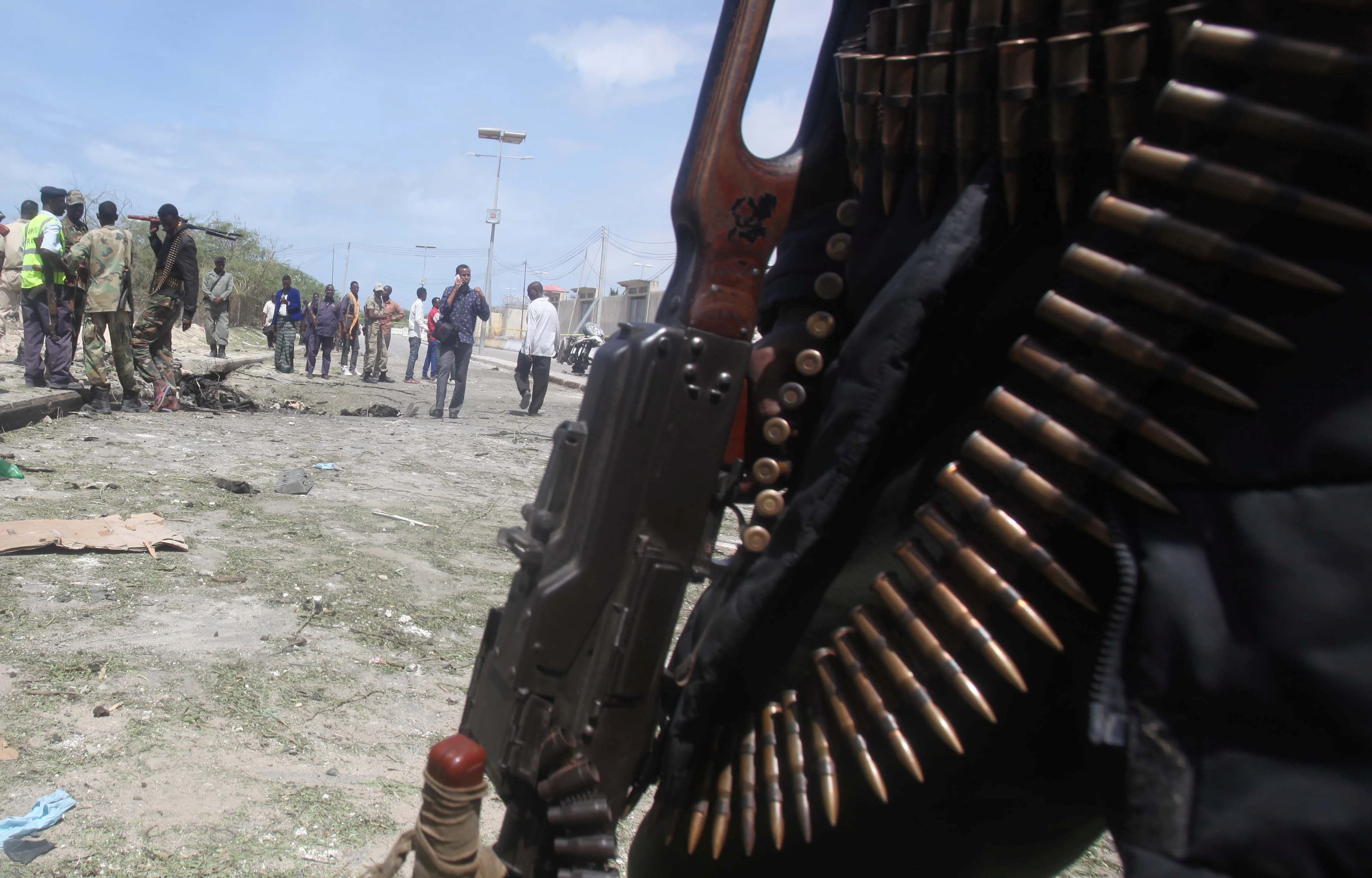 Somali policemen and miltary gather near the scene of a suicide bombing near the African Union's main peacekeeping base in Mogadishu, Somalia, July 26, 2016.