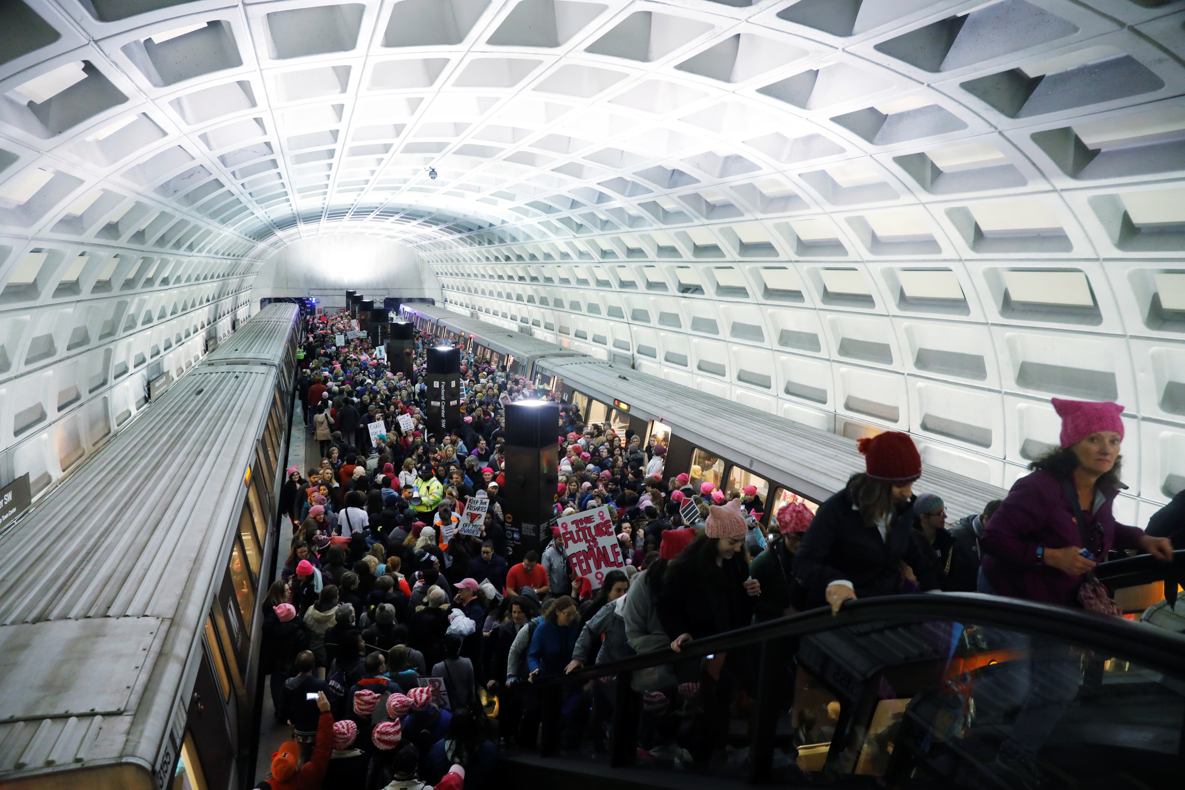 Demonstrators arrive via public transportation to take part in a 