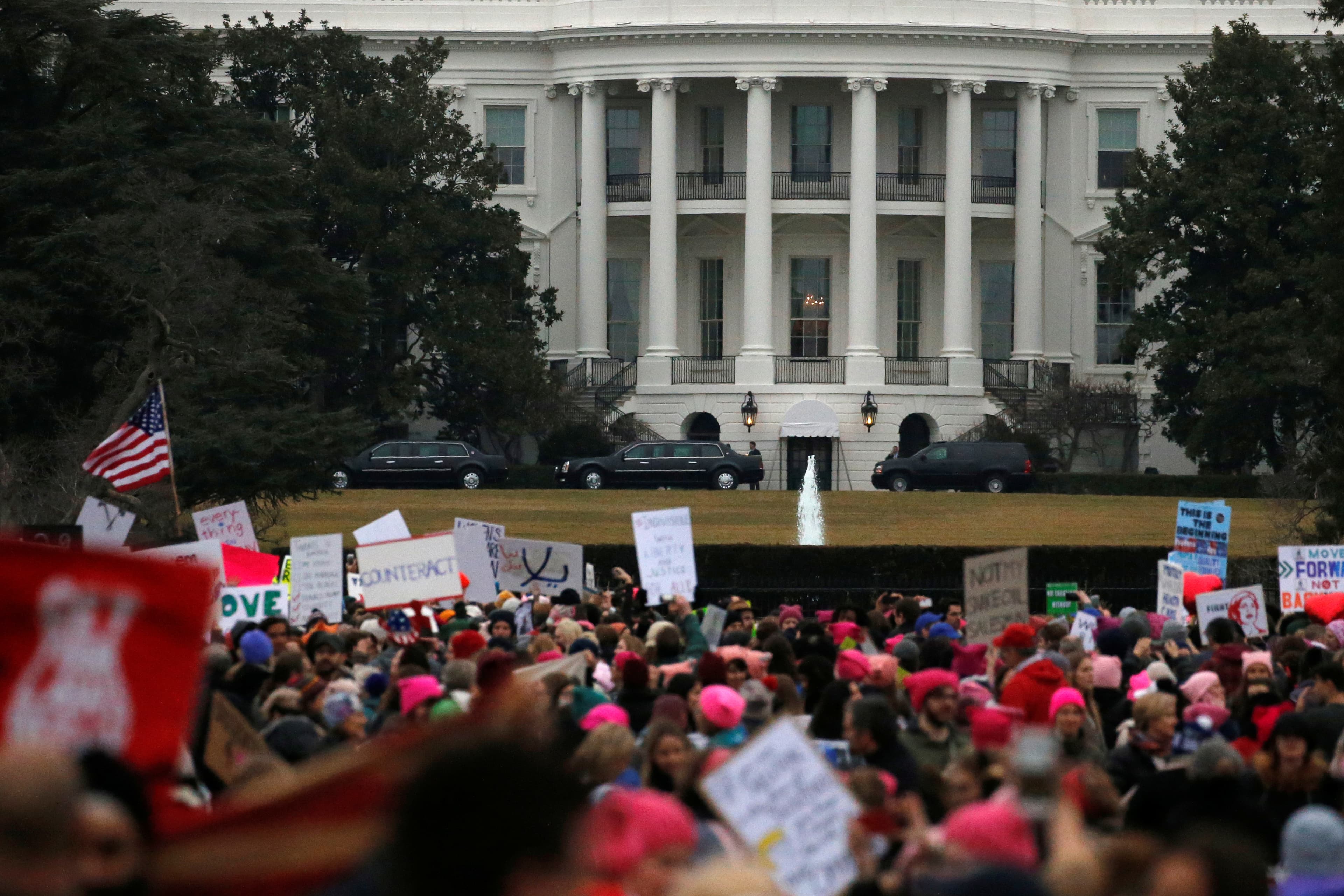 US President Donald Trump's presidential limousines sit in the driveway at the White House as protesters in the Women's March gather nearby in Washington, January 21, 2017.