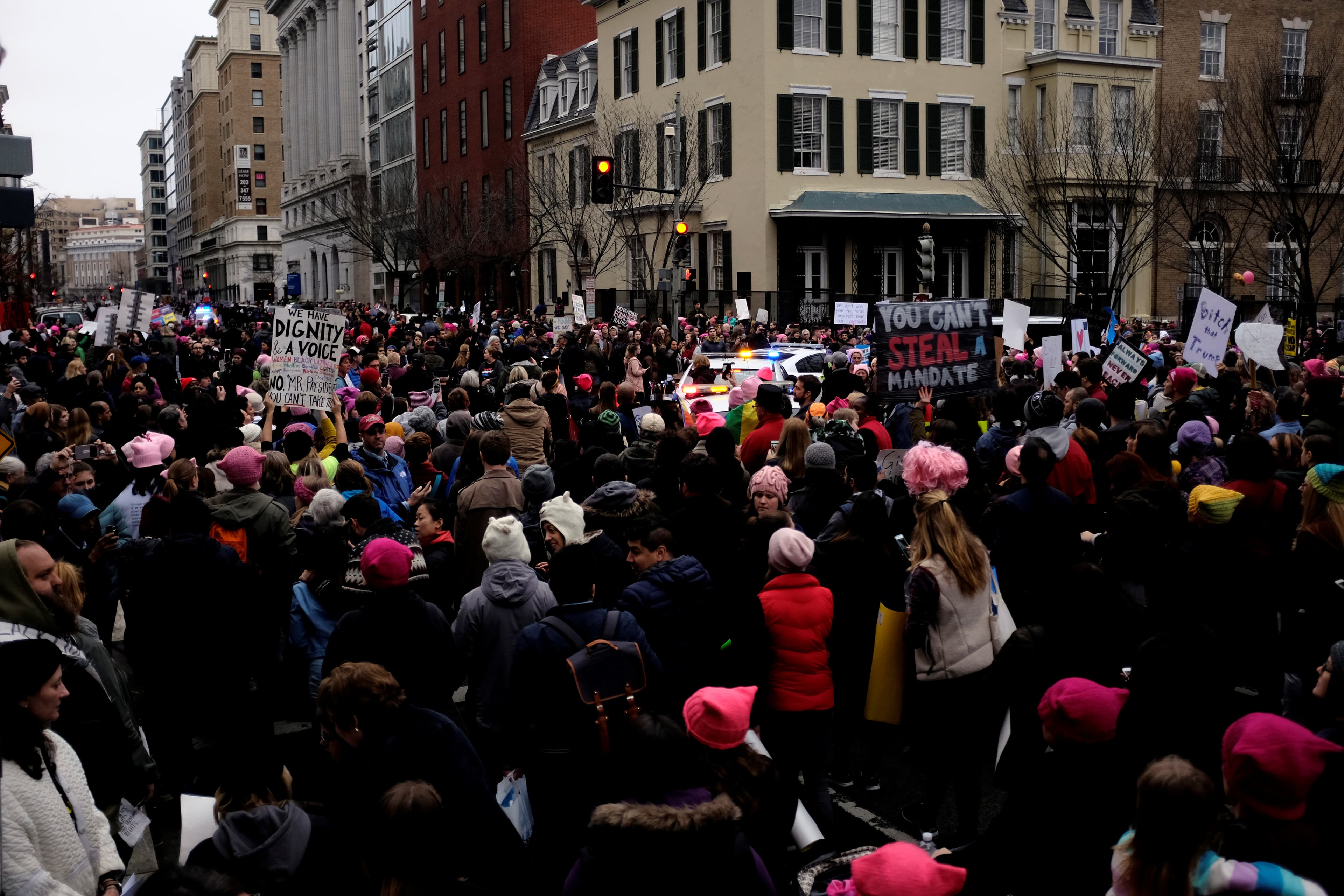 Police vehicles struggle to squeeze through protesters to enter the White House complex during the Women's March on Washington in Washington January 21, 2017.