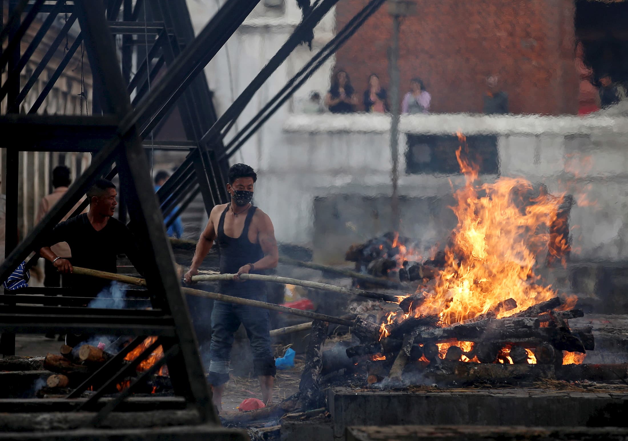 Worker tends cremation fires