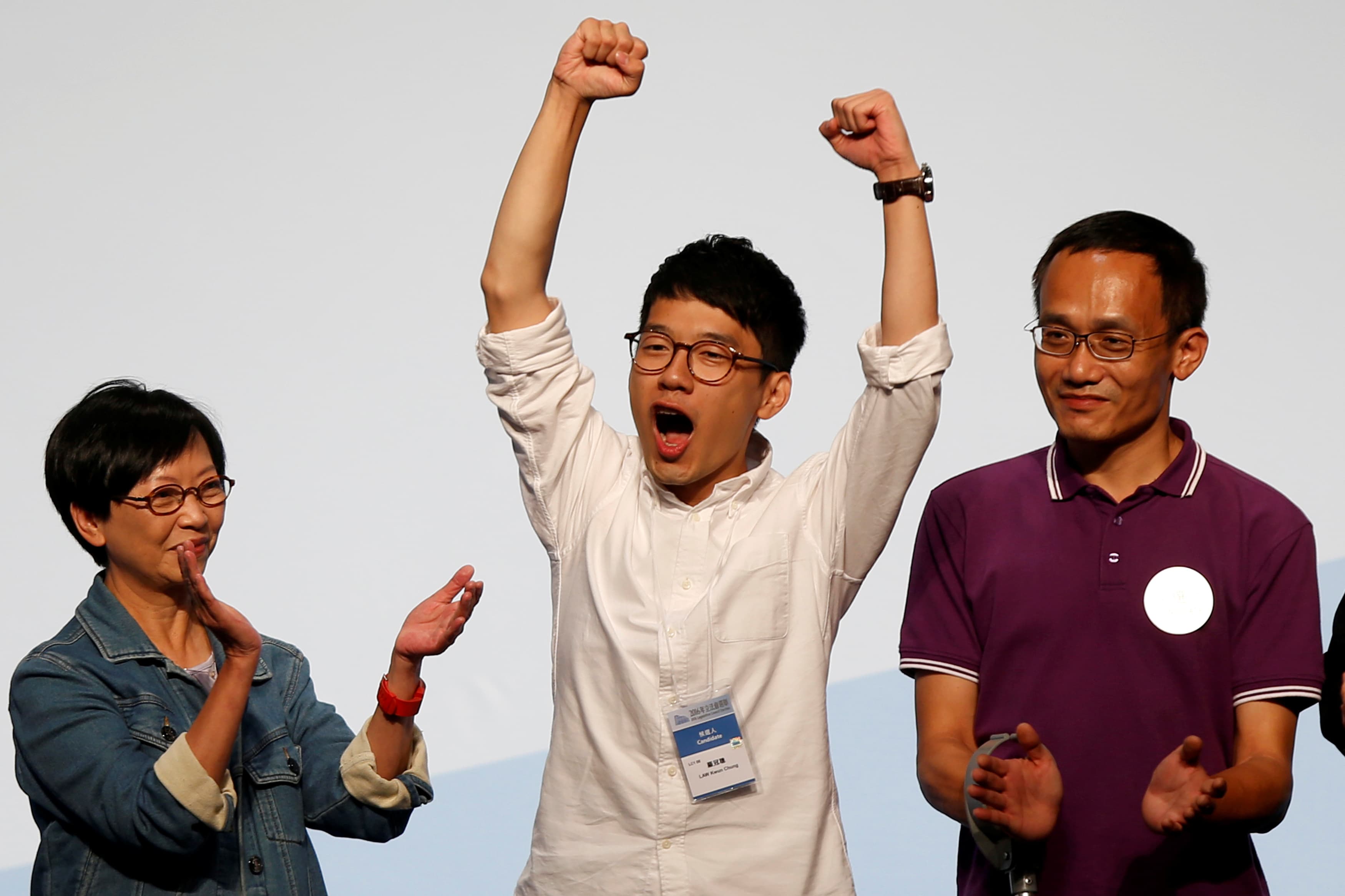 Student leader Nathan Law (C) celebrates on the podium after his win in the Legislative Council election in Hong Kong, China September 5, 2016.