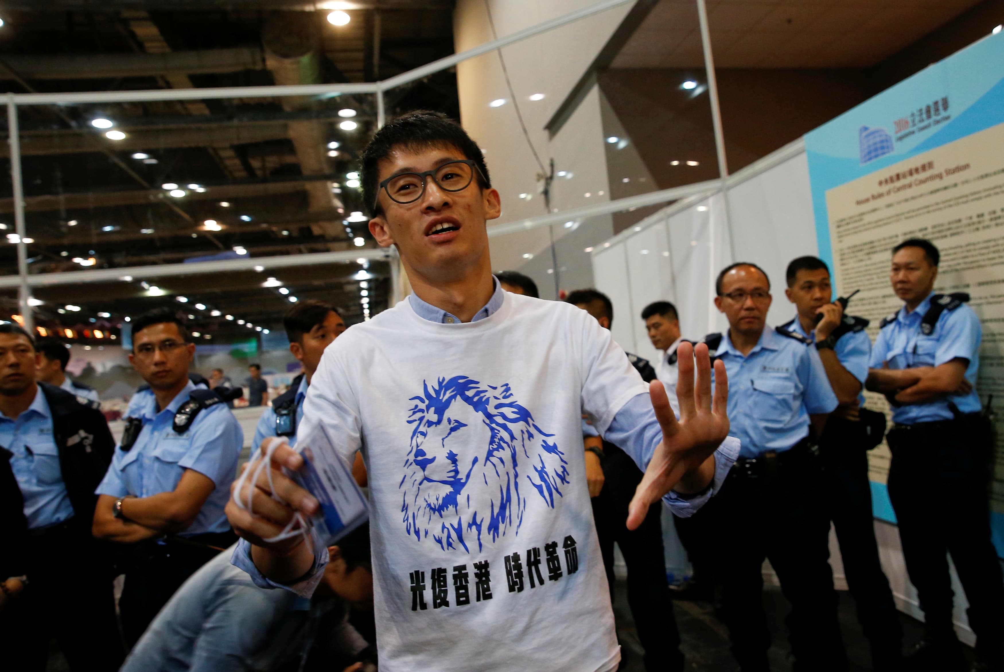 Police stand guard behind candidate Sixtus 