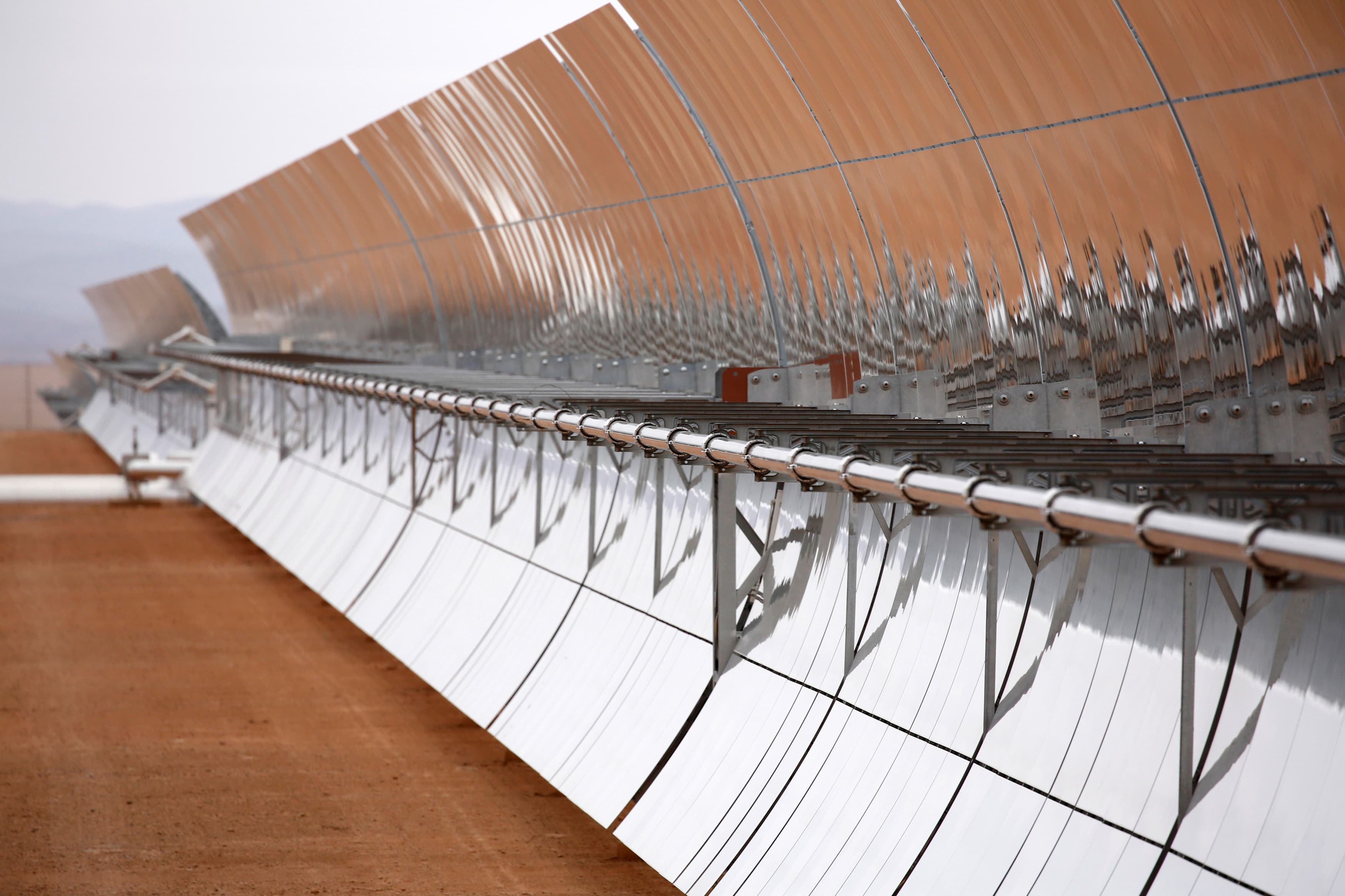 The concentrated solar power (CSP) technology at Morocco's NOOR plant uses thousands of curved mirrors like these to focus the sun's heat on tubes carrying a molten salt solution, heating the liquid up to roughly 700 degrees Fahrenheit. That heat is then