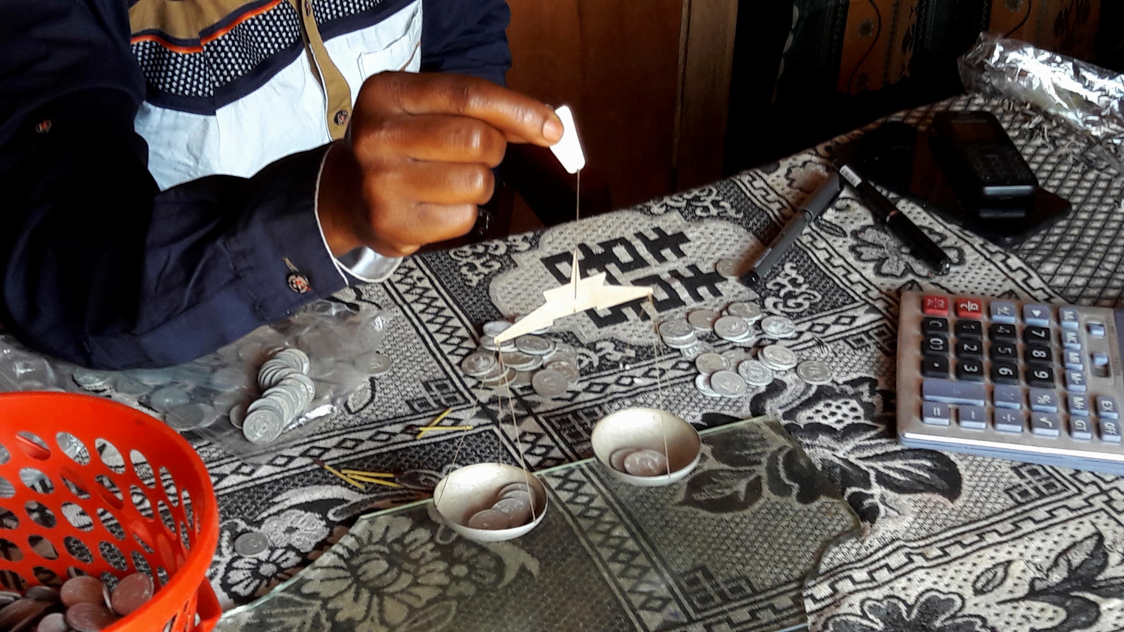 A middleman in the gold trade weighs gold brought in by artisanal miners in Mongbwalu in northeastern DRC, Nov. 15, 2016.