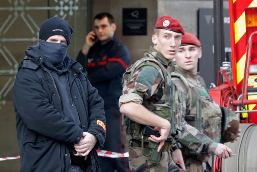 French police, soldiers and firefighters stood in front of the street entrance of the Carrousel du Louvre in Paris, France, on Feb. 3