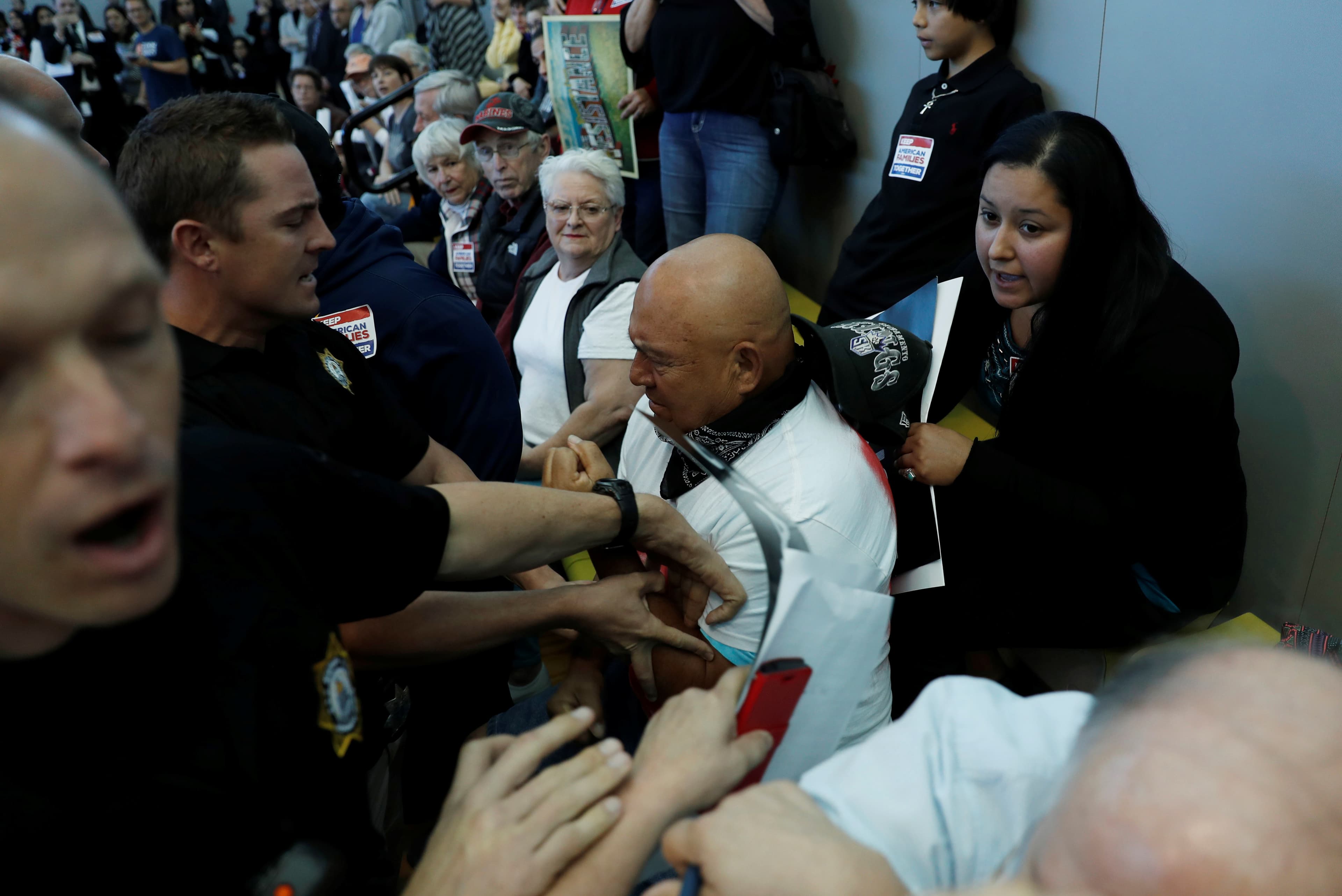 Individuals in crowd being escorted by police