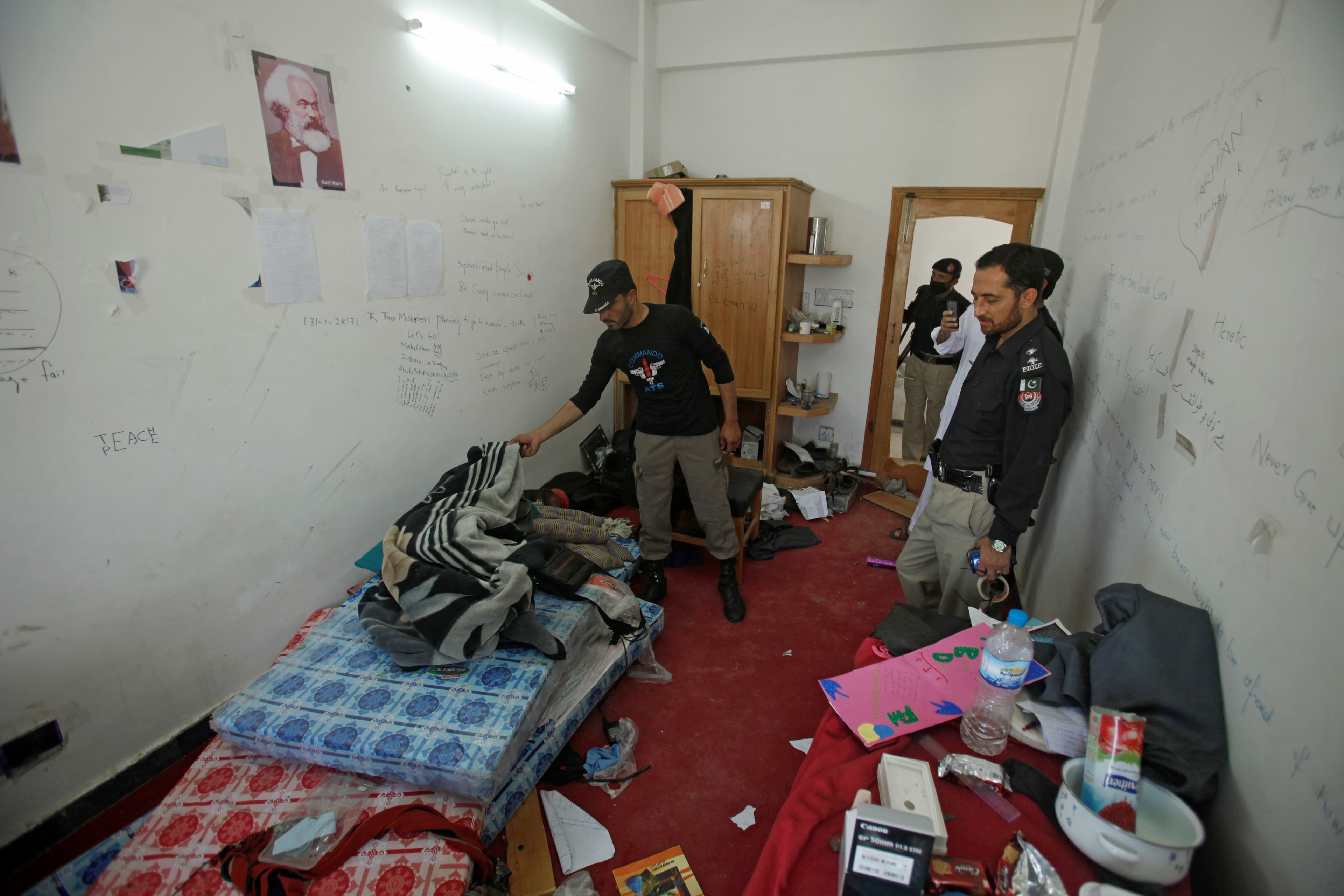 Police search the dorm room of Mashal Khan, accused of blasphemy, who was killed by a mob at Abdul Wali Khan University in Mardan, Pakistan, April 14, 2017.