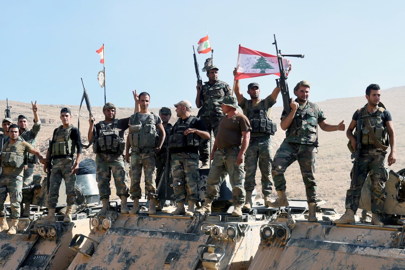 Lebanese army soldiers flash the victory sign in Ras Baalbek, Lebanon, on Aug. 28, 2017.