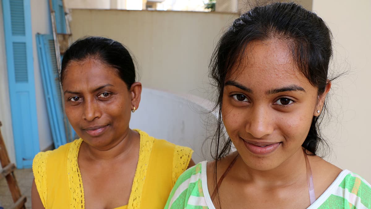 Rainey and her mom stand outside the Migrant Community Center, which provides language classes, cultural programming, and social services for the Asian and African communities in Beirut.