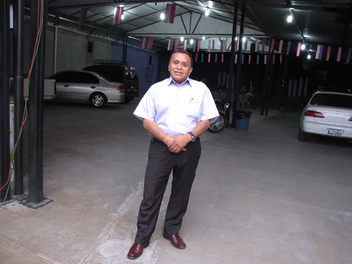 Pastor José Silvero Sanchez, a businessman-turned-pastor, stands where his new evangelical church is being built in Almolonga.