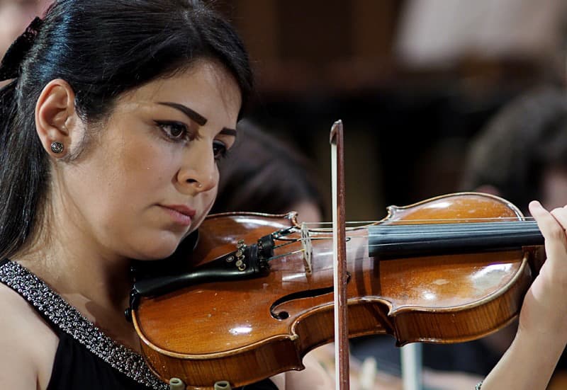SEPO violinist performing at the orchestra’s first concert in Bremen, Germany.