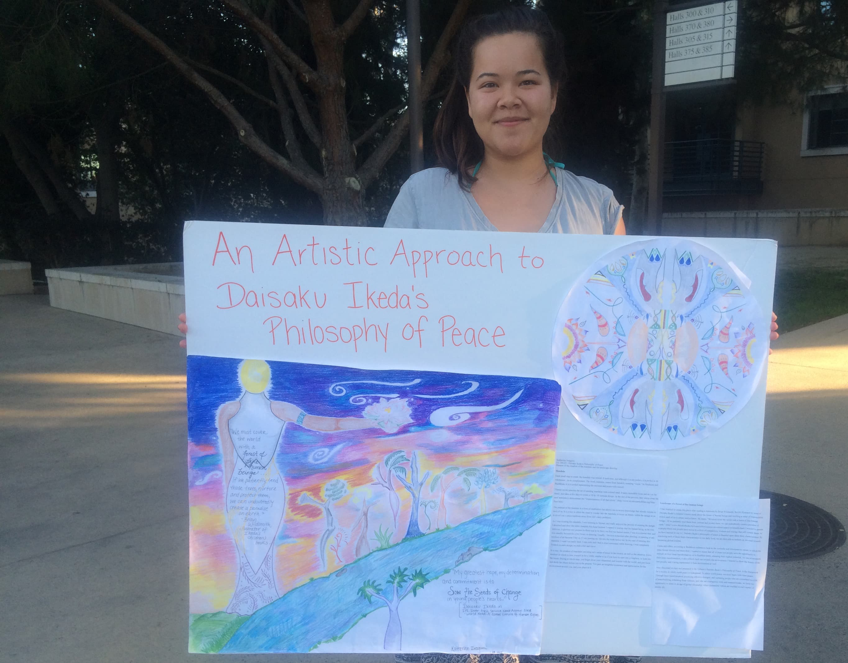 Katie Iwagami displays the poster she did for a research seminar on Soka University founder Daisaku Ikeda’s philosophies of peace.