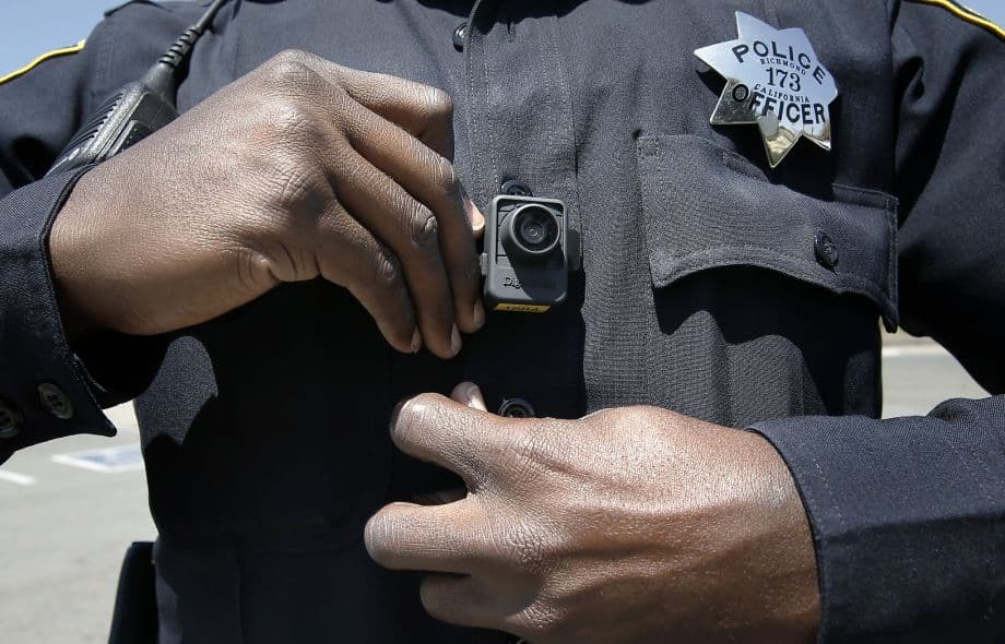 Officer Terry Thomas displays the video camera Richmond Police officers have been wearing since the first of this year, seen while on patrols in Richmond, Calif.
