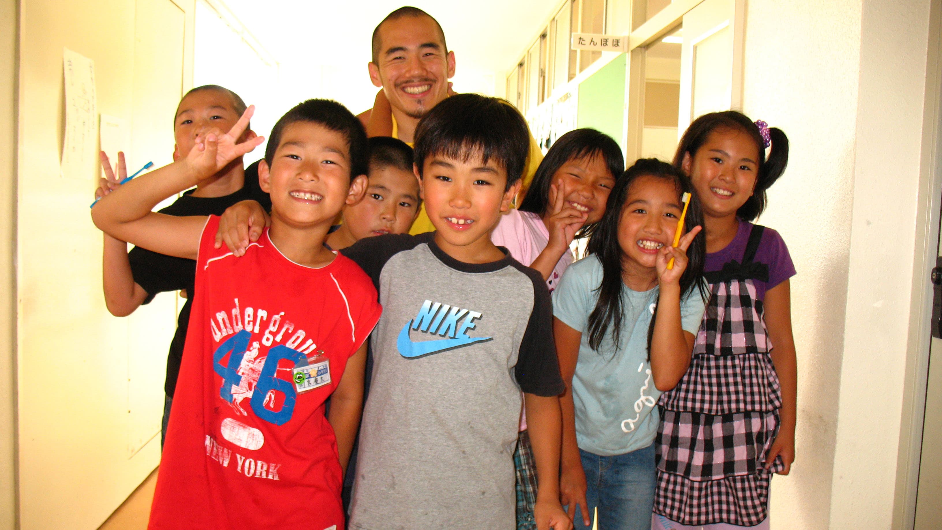 Miki Dezaki with elementary school students he taught in Japan. When he asked his high school students if they thought there was racism in Japan, two or three out of 40 said 'yes.'