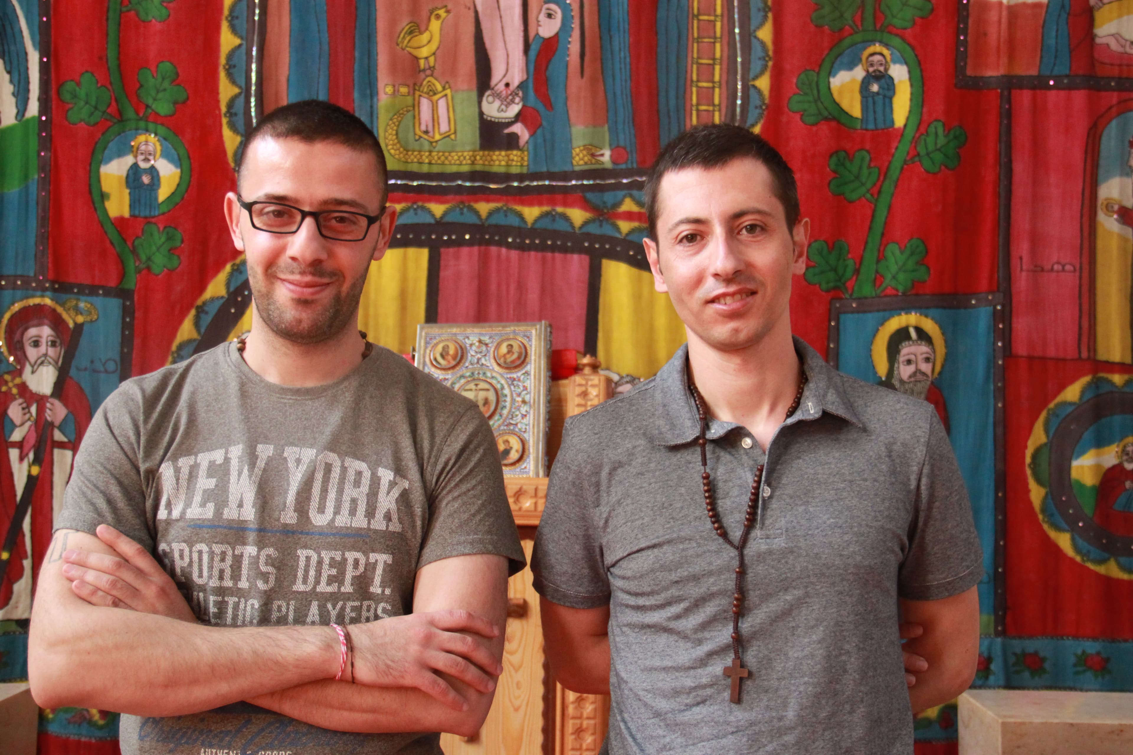 Tarek Bakhous (l) and Wassim Awad, two Syrian Christian refugees, in the Syriac Orthodox Church of Antiochia in Berlin, where the liturgy is in Syriac, a dialect of Aramaic.