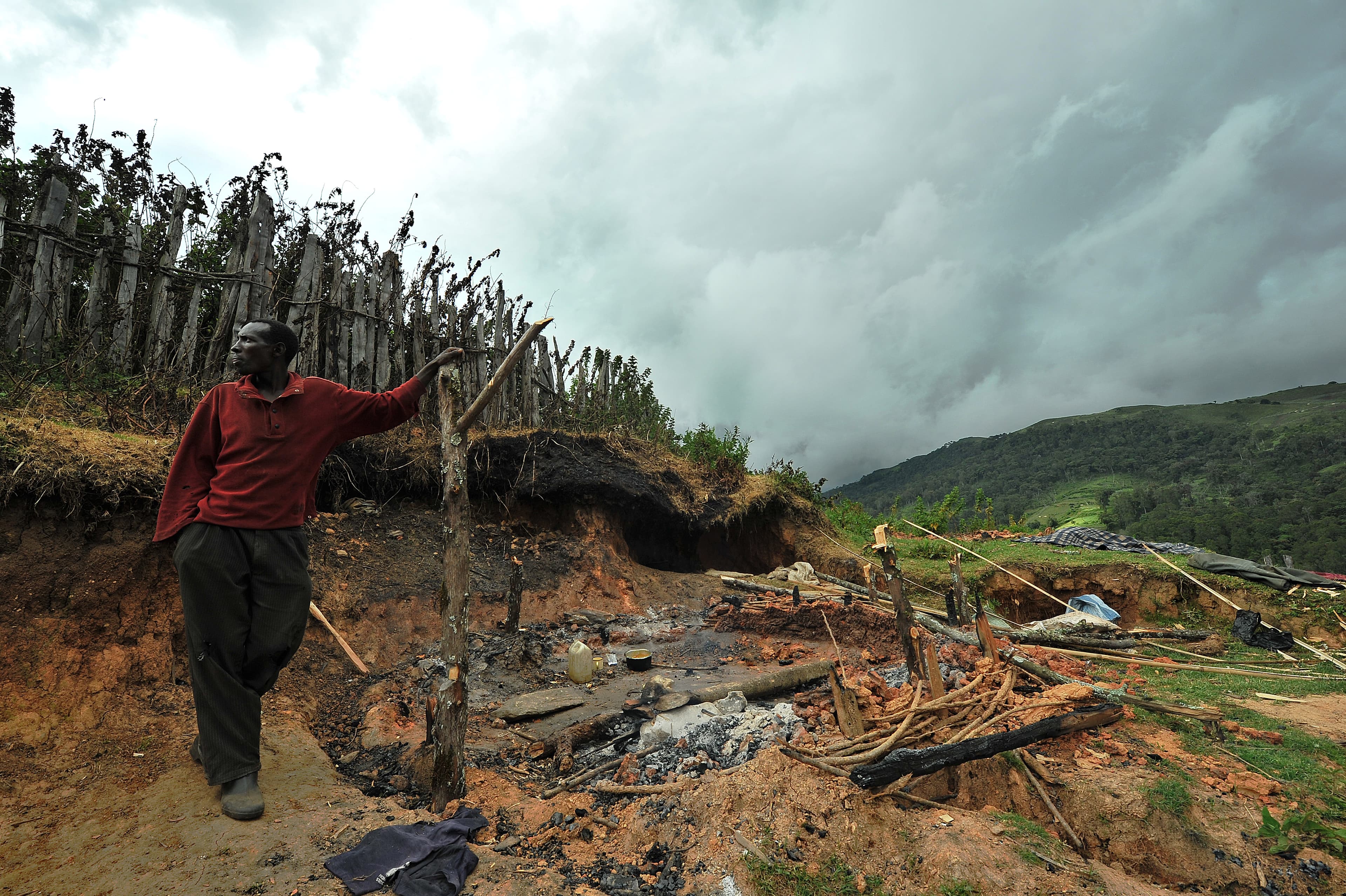 Joseph Kilimo Chebet, father of five, standing next to the charred remains of his home. He and other Sengwer said Kenya Forest Service officers had set it afire hours before.