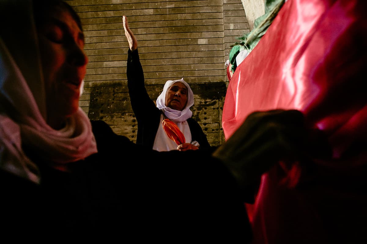 Hure Shamo, left, and Hure Kaso Murad, center, say a prayer while making wishes for better days for the Yazidi people.