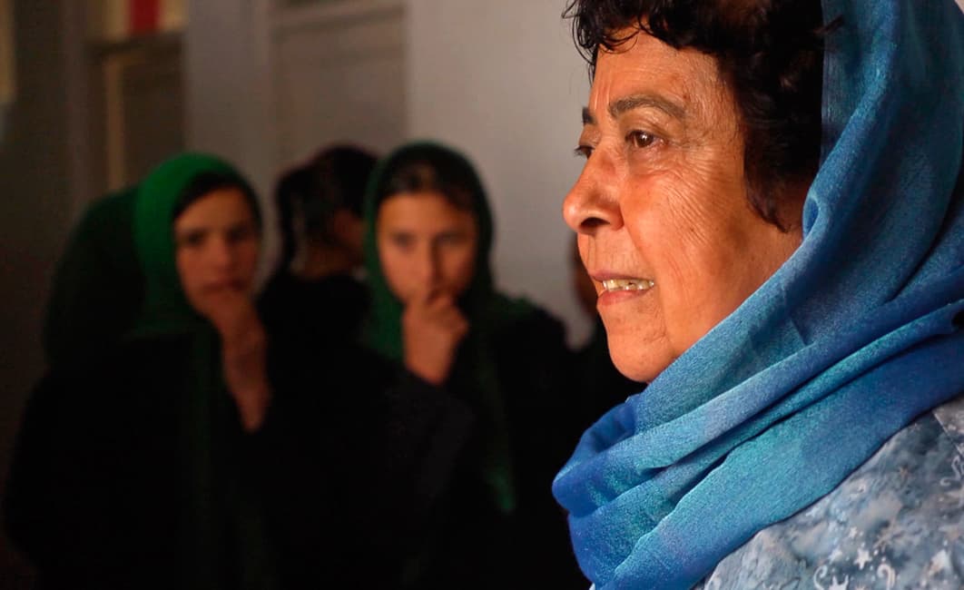 Razia Jan greeting students as they arrive in school at the beginning of the day.