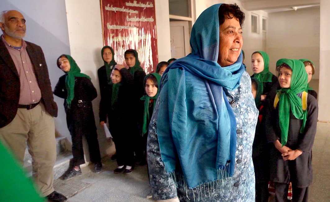 Razia Jan waiting to greet students as they arrive at the beginning of the school day.