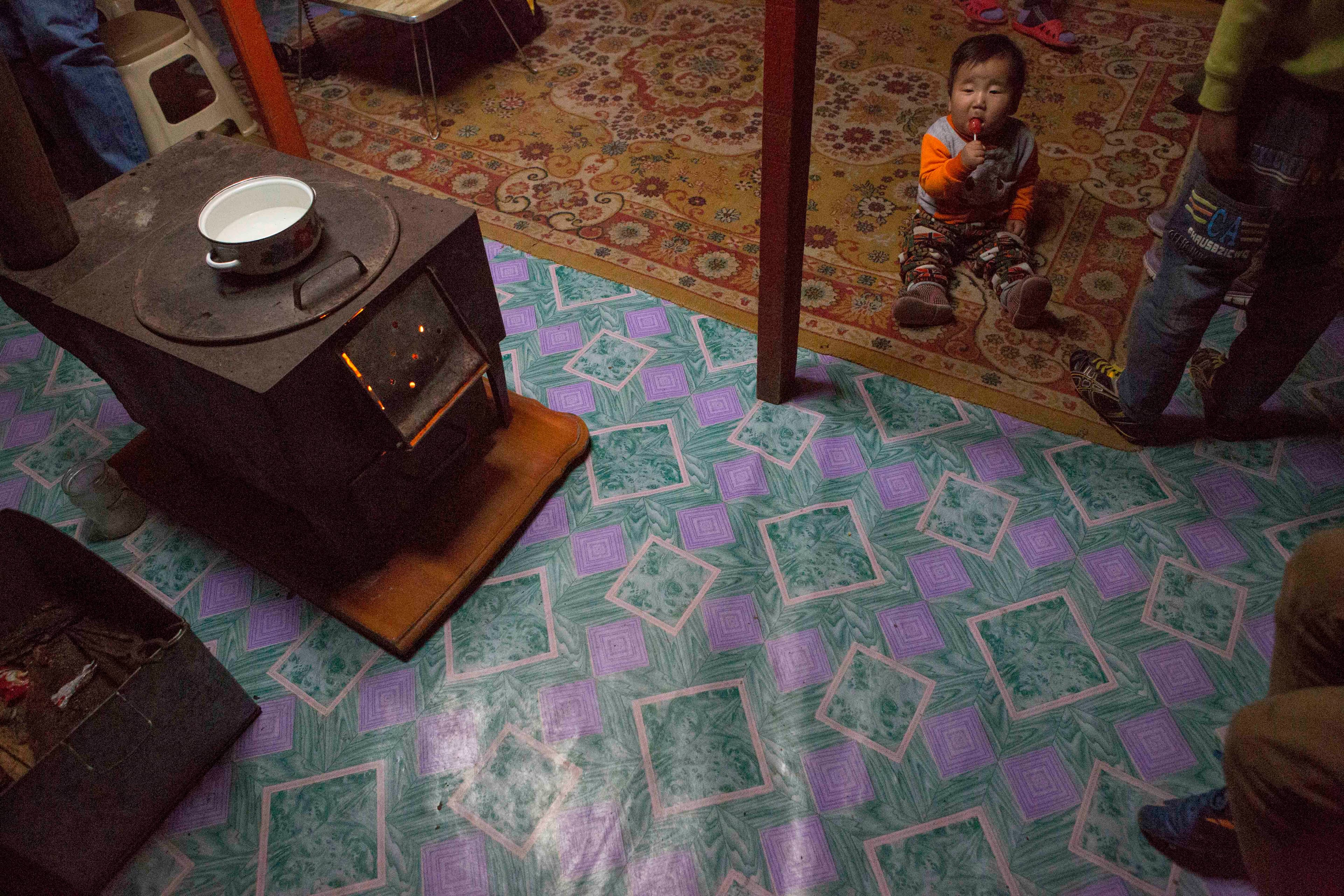 Eight month-old Munkh-erdene sits next to his family’s traditional stove in thier ger, or yurt in Ulaanbaatar. The stoves are meant to burn wood or animal dung, but many families use them to burn coal, causing a spike in air pollution in the winter.