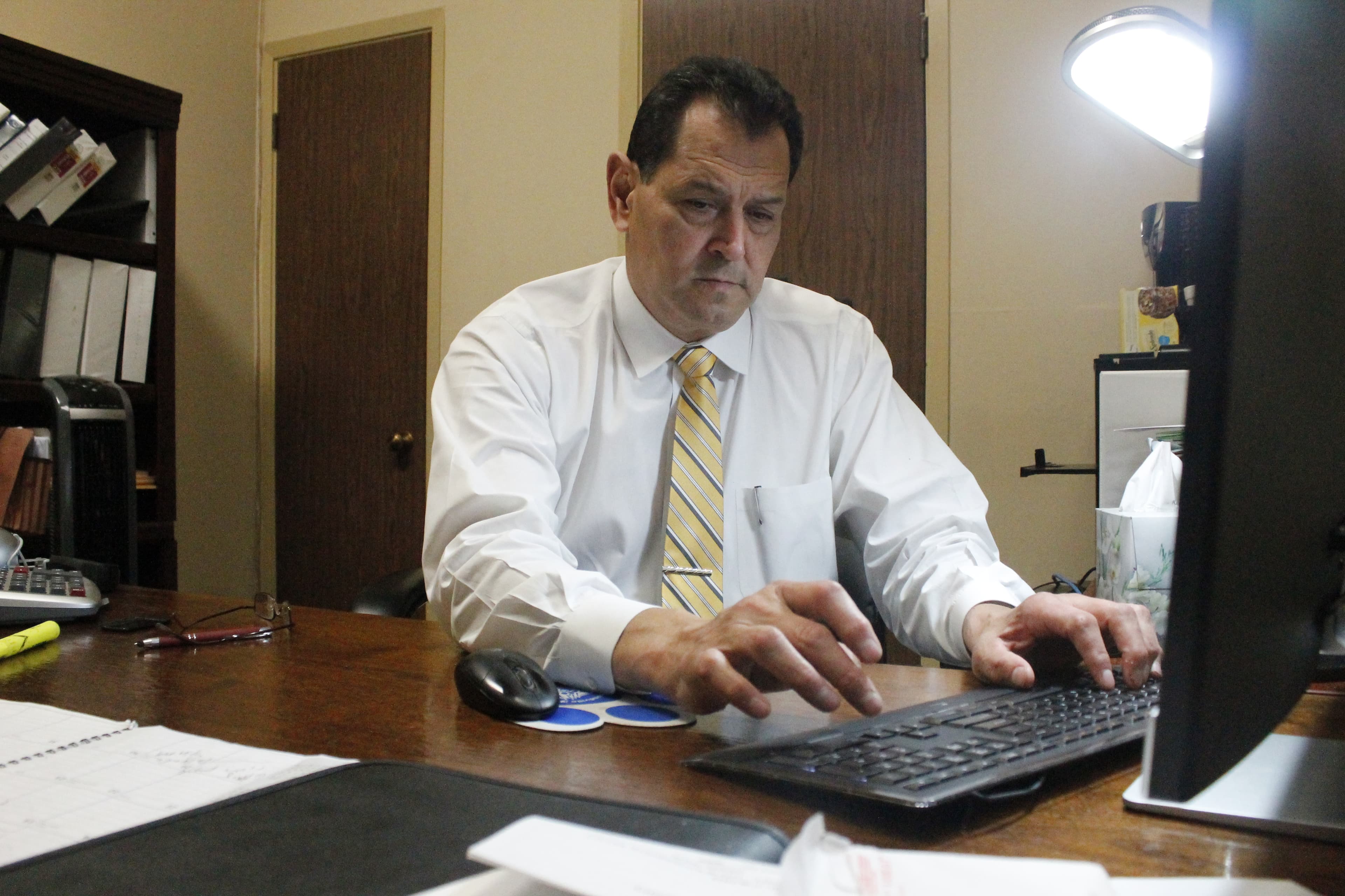 Man on phone, at computer