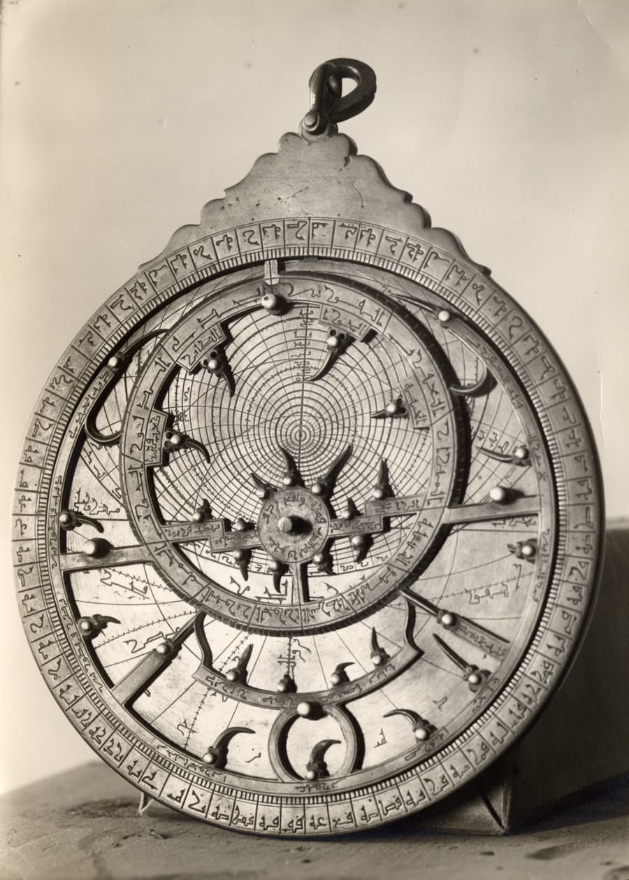 black and white photo of round technical tool with numbers and dials