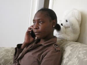 Carmine Pierre calls her 11-year-old son Marc Kelly in Haiti. She hasn't seen him since he was five. (Photo: Amy Bracken)