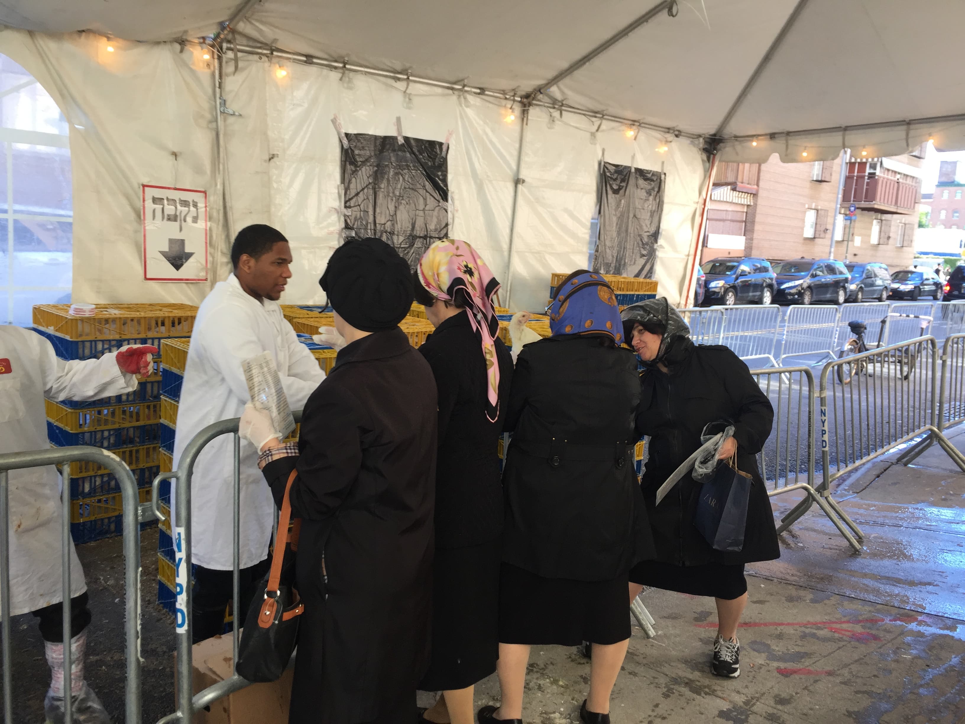 Women line up to get their chicken for the ritual of Kaparot.