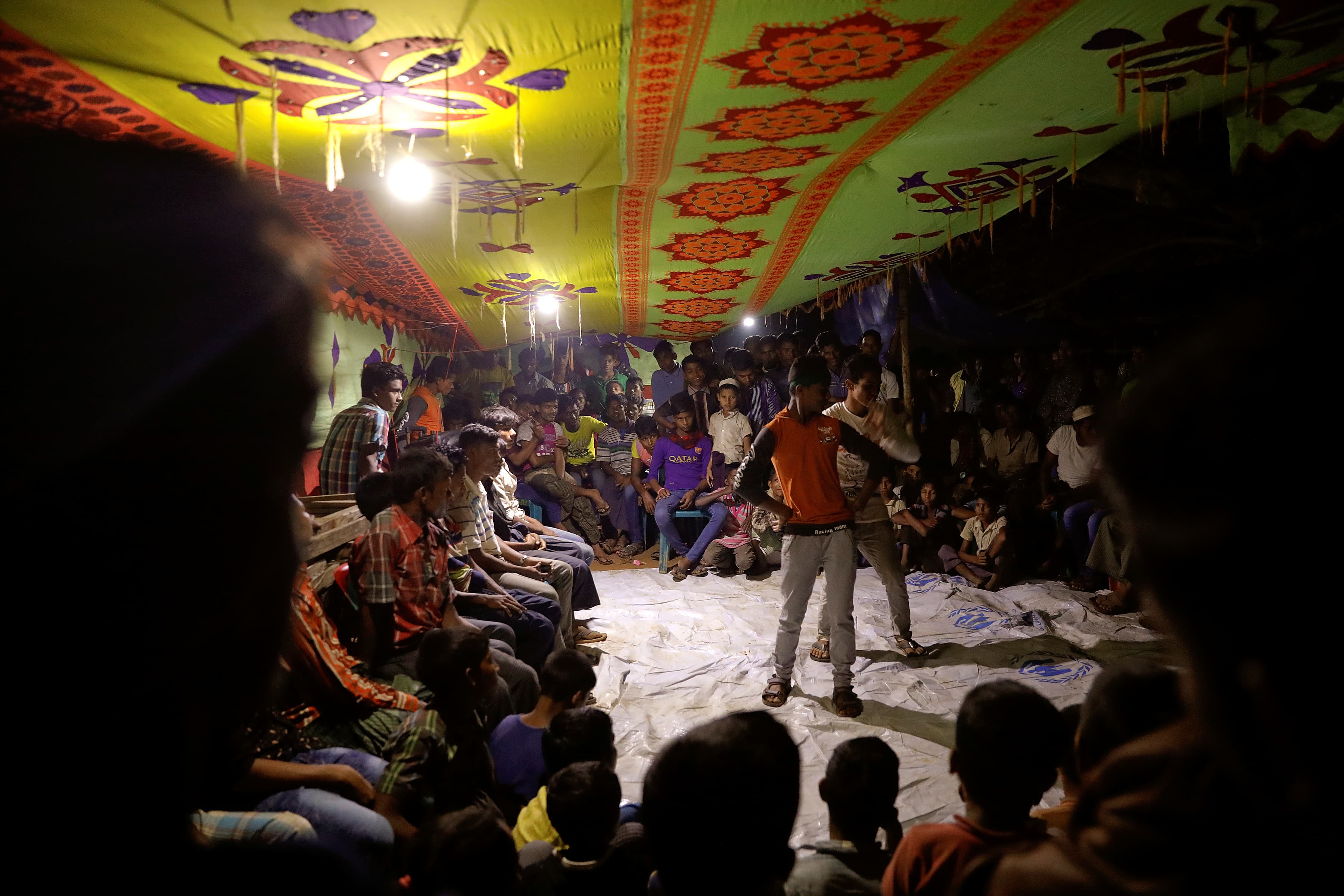 A professional dancer and his two assistants take to the floor with flashy moves to warm up the crowd.