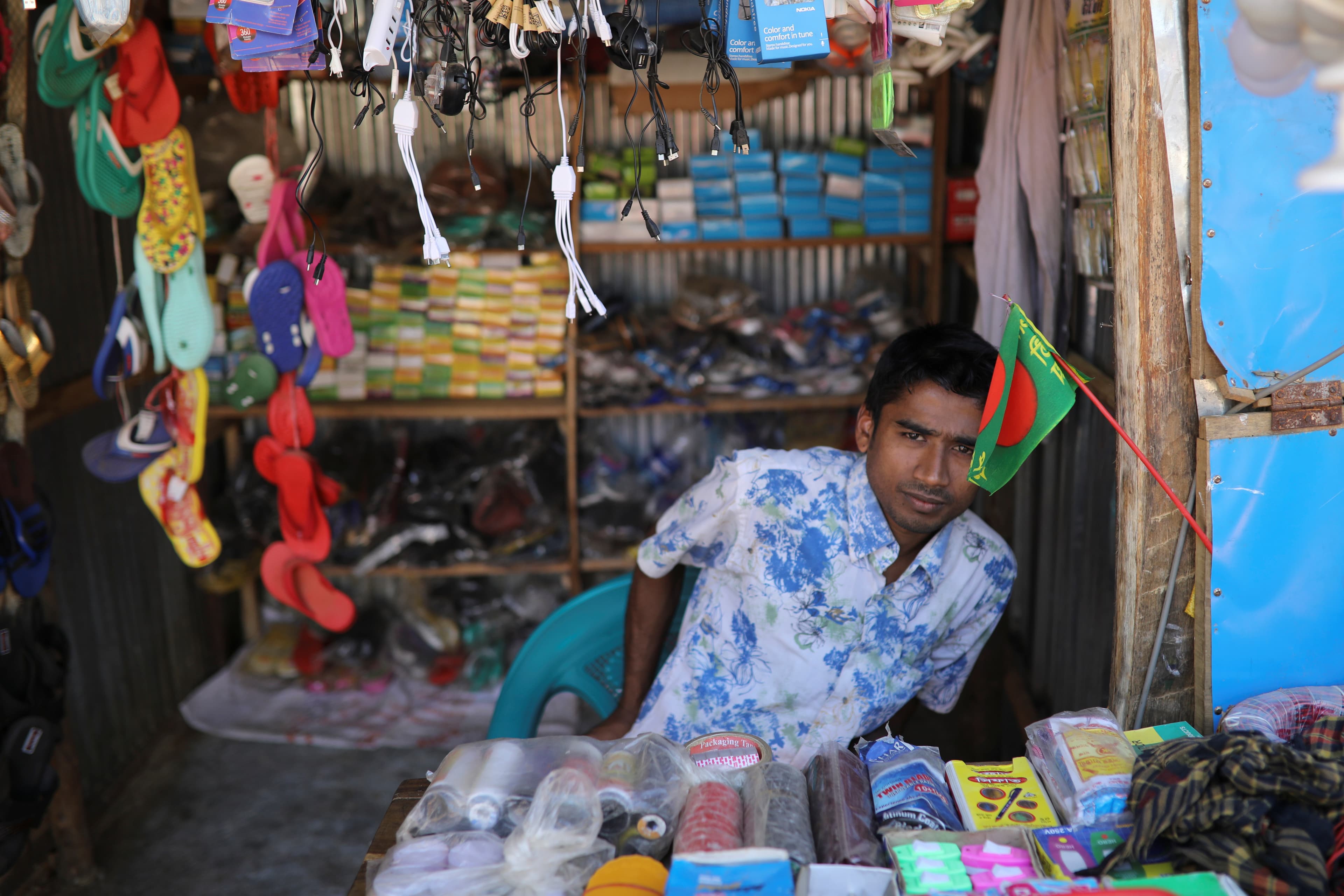 Saddam Hussein works at his family's shop at the Kutupalong refuge