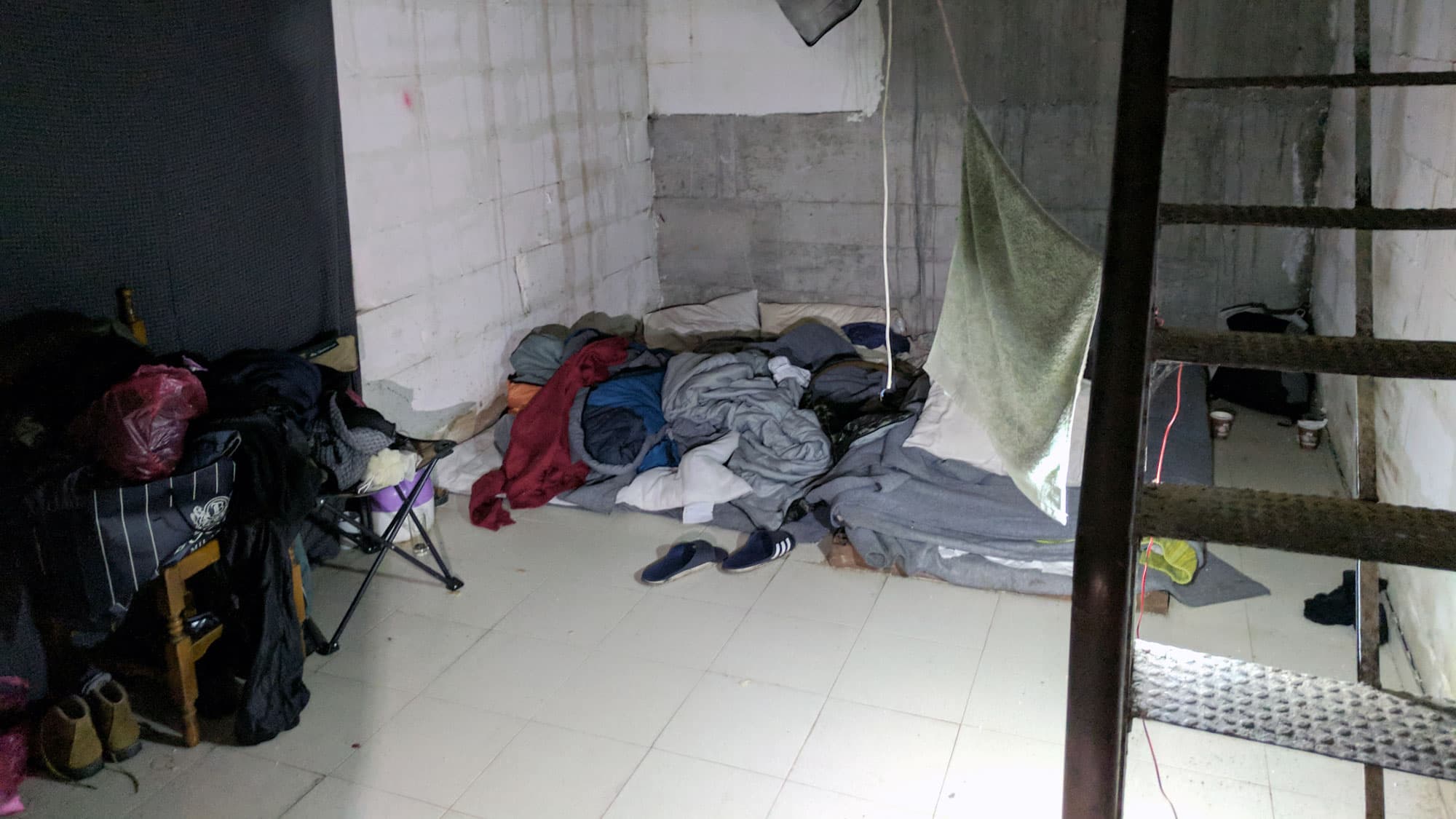 They sleep in small rooms at the edges of the warehouse.